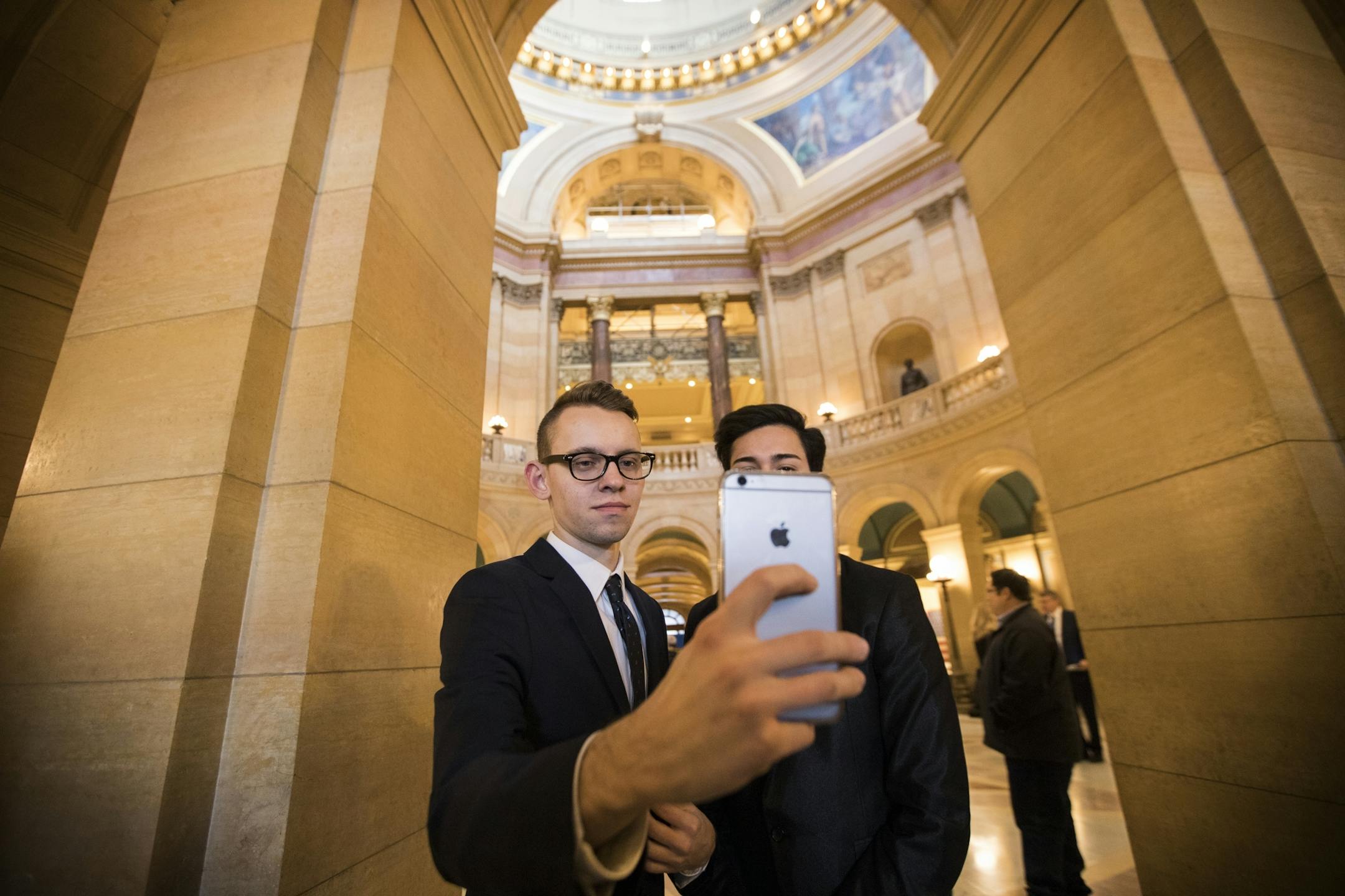 Nikita Skorykh, left, and Jazer Mauricio take a selfie in the rotunda after a prayer service.