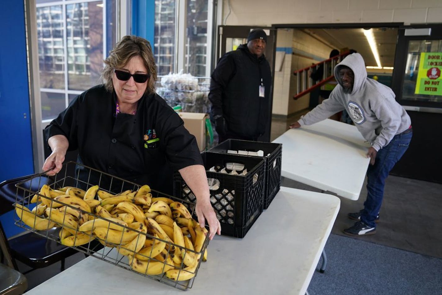 Food service assistant Bernadette Traeger got some help moving her station indoors to get her out of the cold weather Tuesday at Northeast Middle School.