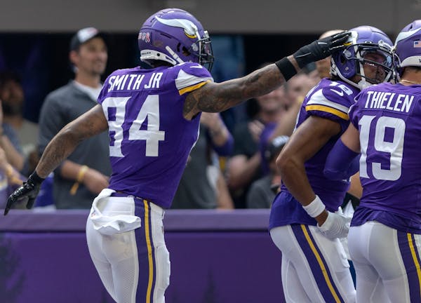 Irv Smith (84) of the Minnesota Vikings celebrates with Justin Jefferson (19) in the first quarter Sunday, September 11, 2022, at U.S. Bank Stadium in