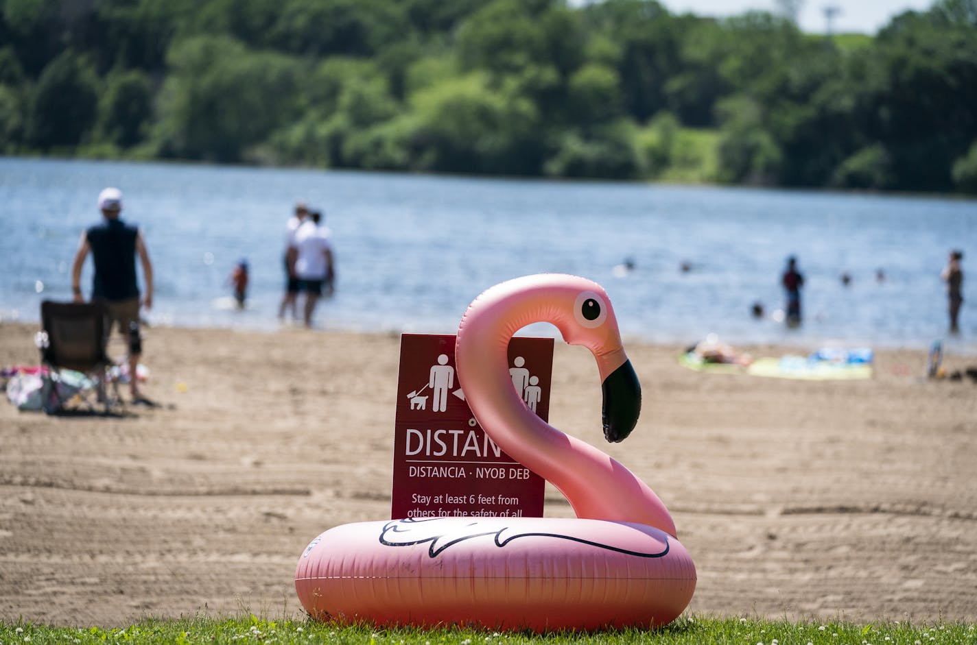 A social distancing reminder at the beach at Fort Snelling State Park on Monday when the high was in the 90s.