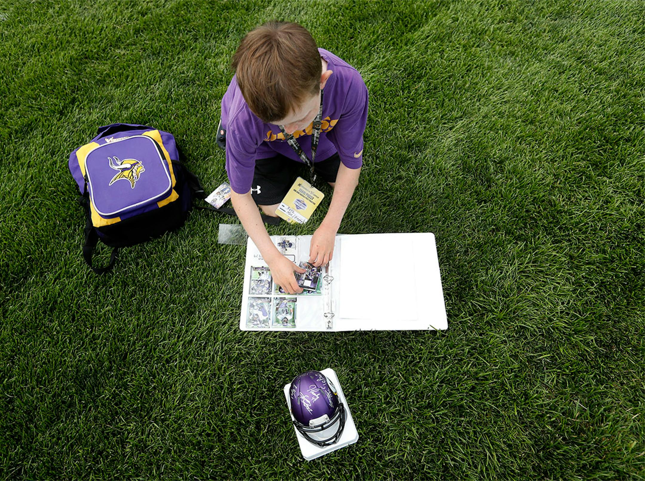 Alex Nemo, 9, of Woodbury organized his Vikings cards and souvenirs after getting an autograph. ] CARLOS GONZALEZ cgonzalez@startribune.com - July 29, 2016, Mankato, MN, Minnesota State University, Mankato, Minnesota Vikings Training Camp