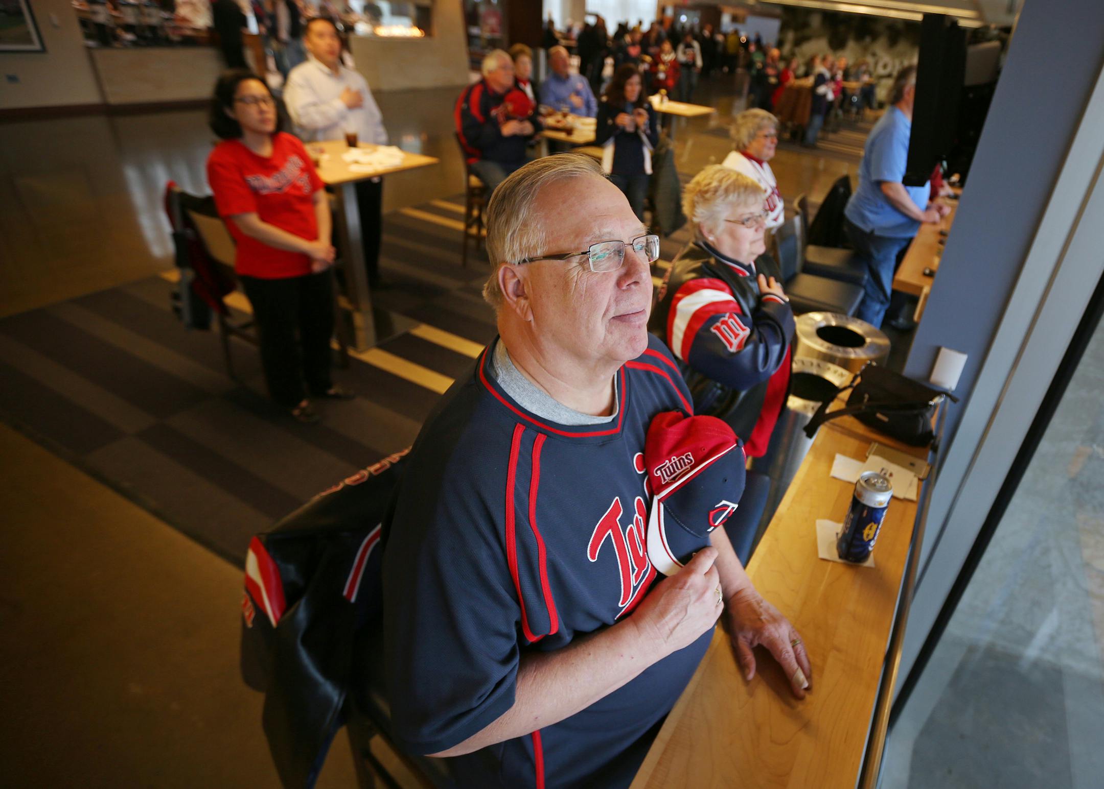 Twins season ticket holders Glen Larson and his wife Ann Larson stood during the anthem at Target Field .Minnesota Twins fans watched there team open the season against the Detroit Tigers on the big screen at Target Field Monday April 6, 2015 in Minneapolis, Minnesota. ] Jerry Holt/ Jerry.Holt@Startribune.com ORG XMIT: MIN1504061302062387