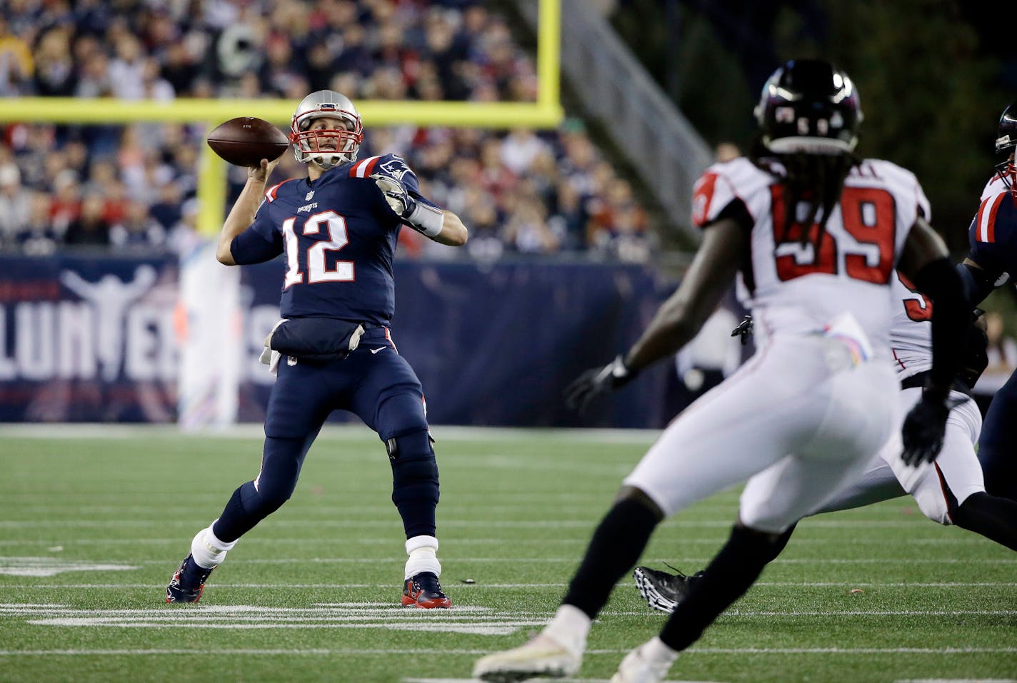 New England Patriots quarterback Tom Brady passes under pressure from Atlanta Falcons linebacker De'Vondre Campbell (59) during the first half of an NFL football game against the Atlanta Falcons, Sunday, Oct. 22, 2017, in Foxborough, Mass. (AP Photo/Steven Senne) ORG XMIT: NYOTK