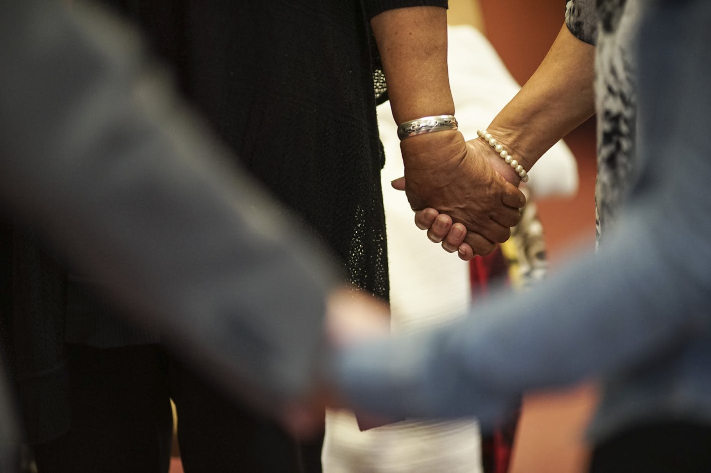 In this 2015 photo, a group of women held hands during a healing session at the Minnesota Indian Women's Center in Minneapolis.