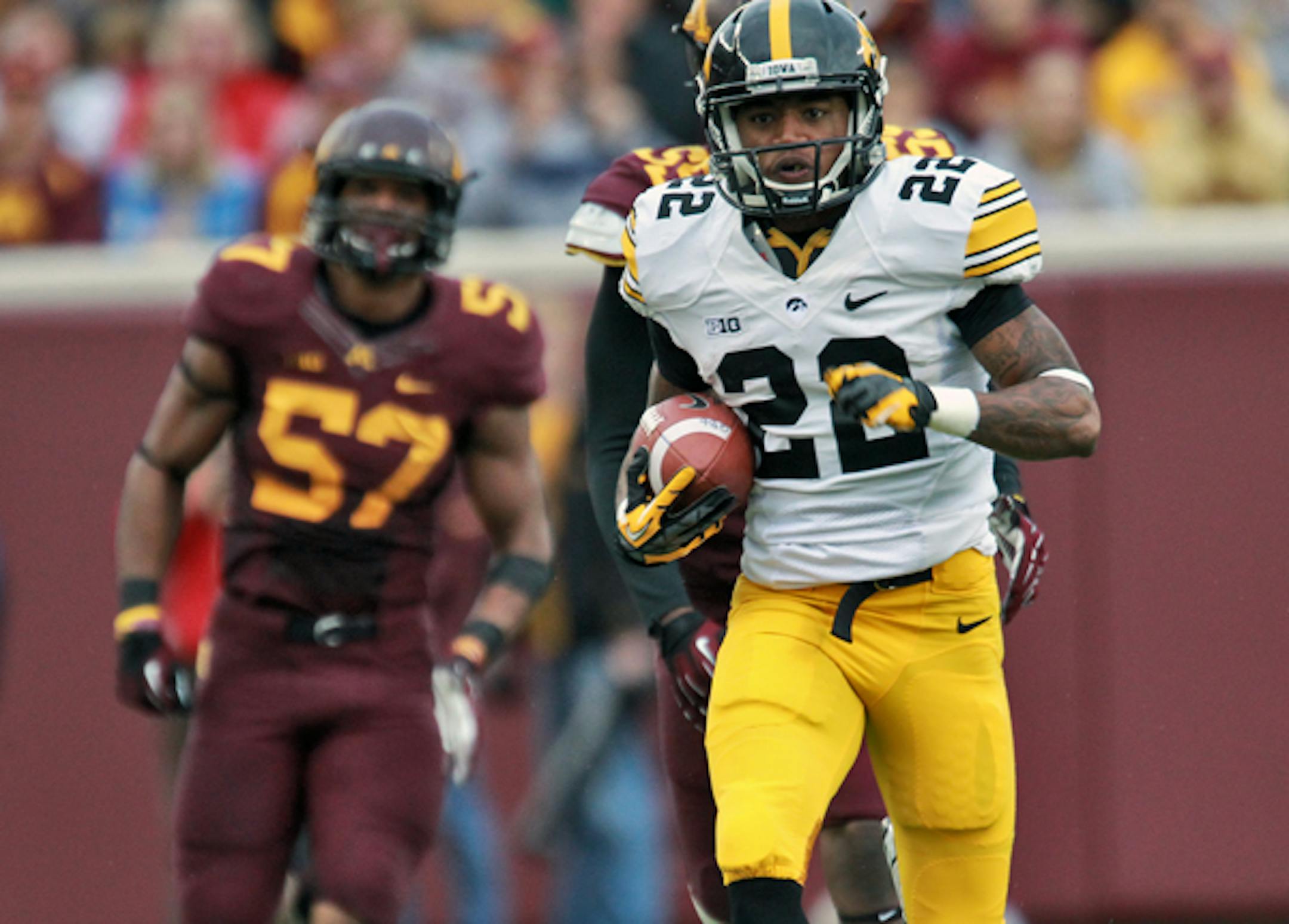 Iowa Hawkeyes va. Minnesota Gophers football. Iowa receiver Damond Powell (22) led Minnesota defenders down the field as he scored on a 74-yard touchdown run in first half action. (MARLIN LEVISON/STARTRIBUNE(mlevison@startribune.com)