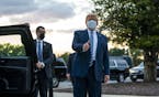 President Donald Trump gestures a thumbs up as he departs the Walter Reed Medical Center in Bethesda, Md., after testing positive for COVID-19 and spe