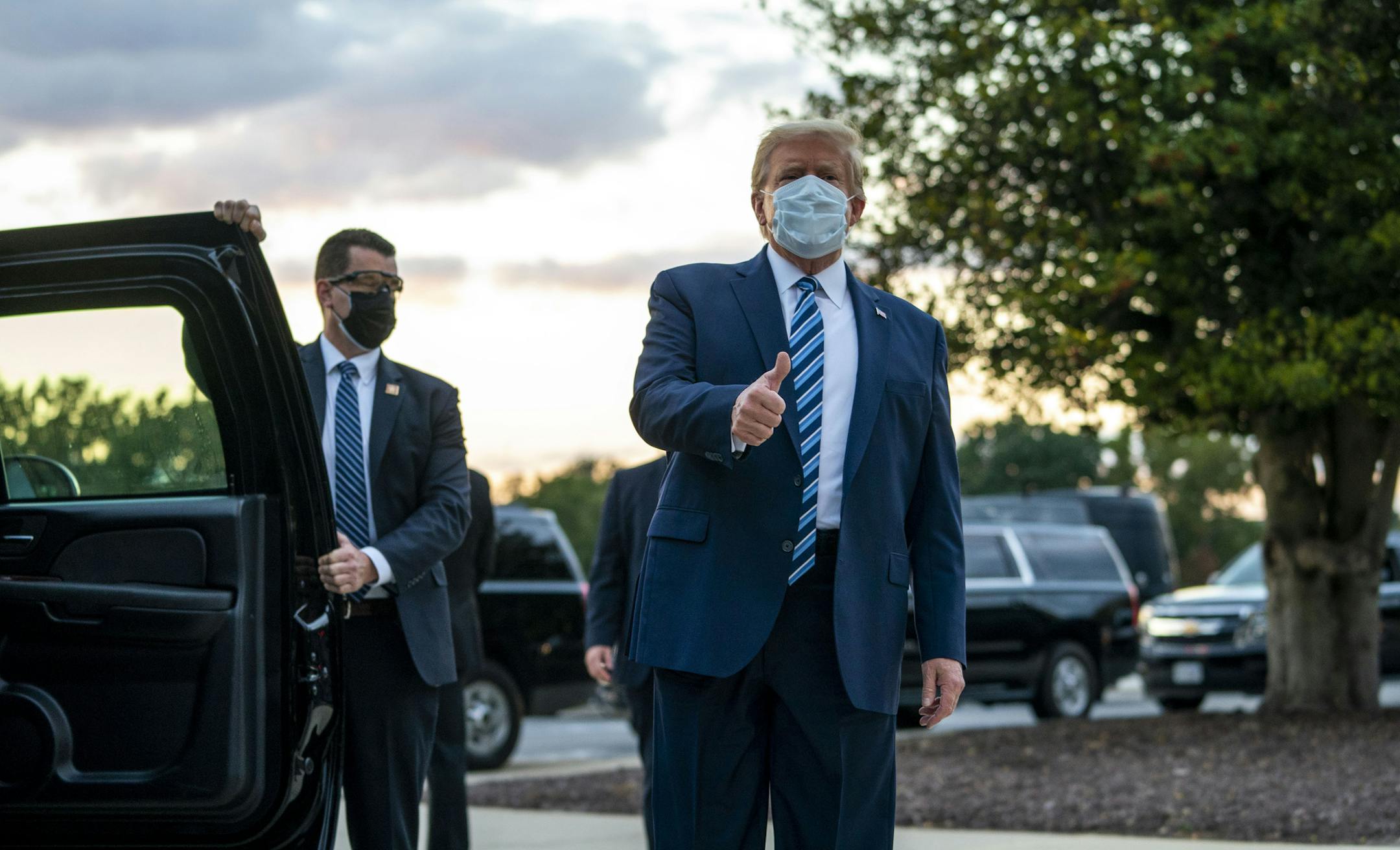 President Donald Trump gestures a thumbs up as he departs the Walter Reed Medical Center in Bethesda, Md., after testing positive for COVID-19 and spending four days at the facility, on Oct. 5, 2020. The president's medical treatment makes a point that undoes months of propaganda: COVID-19 is clearly a very bad disease. (Doug Mills/The New York Times)