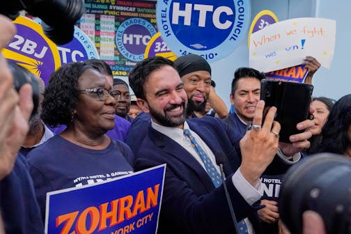 Democrat mayoral candidate Zohran Mamdani takes photos with union members during a rally at the Hotel & Gaming Trades Council headquarters in New York, Wednesday, July 2, 2025.