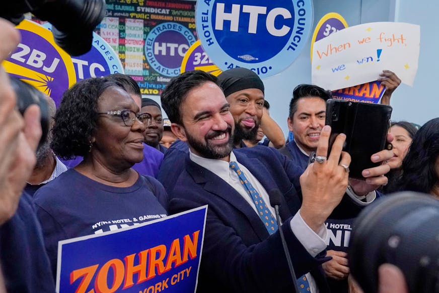Democrat mayoral candidate Zohran Mamdani takes photos with union members during a rally at the Hotel & Gaming Trades Council headquarters in New York, Wednesday, July 2, 2025.