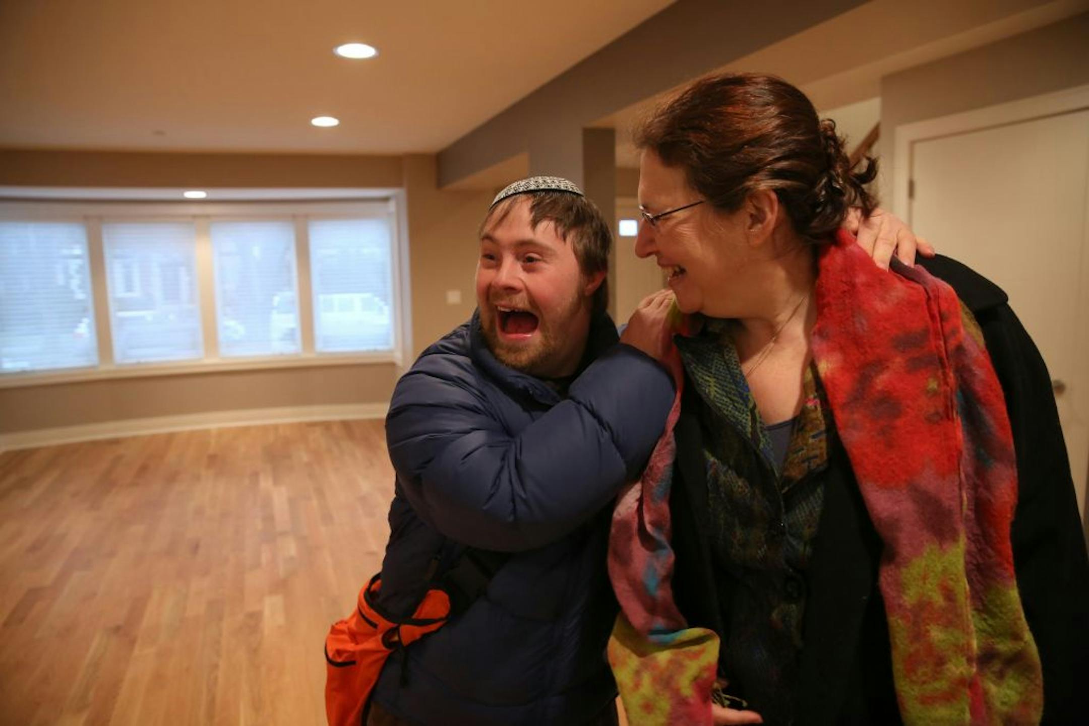 Jacob Mosbacher, 25, left, is excited to show his mom, Joan Katz, his new home as he and other residents get their first look inside their new residence, Libenu Home of West Rogers Park in Chicago, during a walk-through, December 24, 2012.