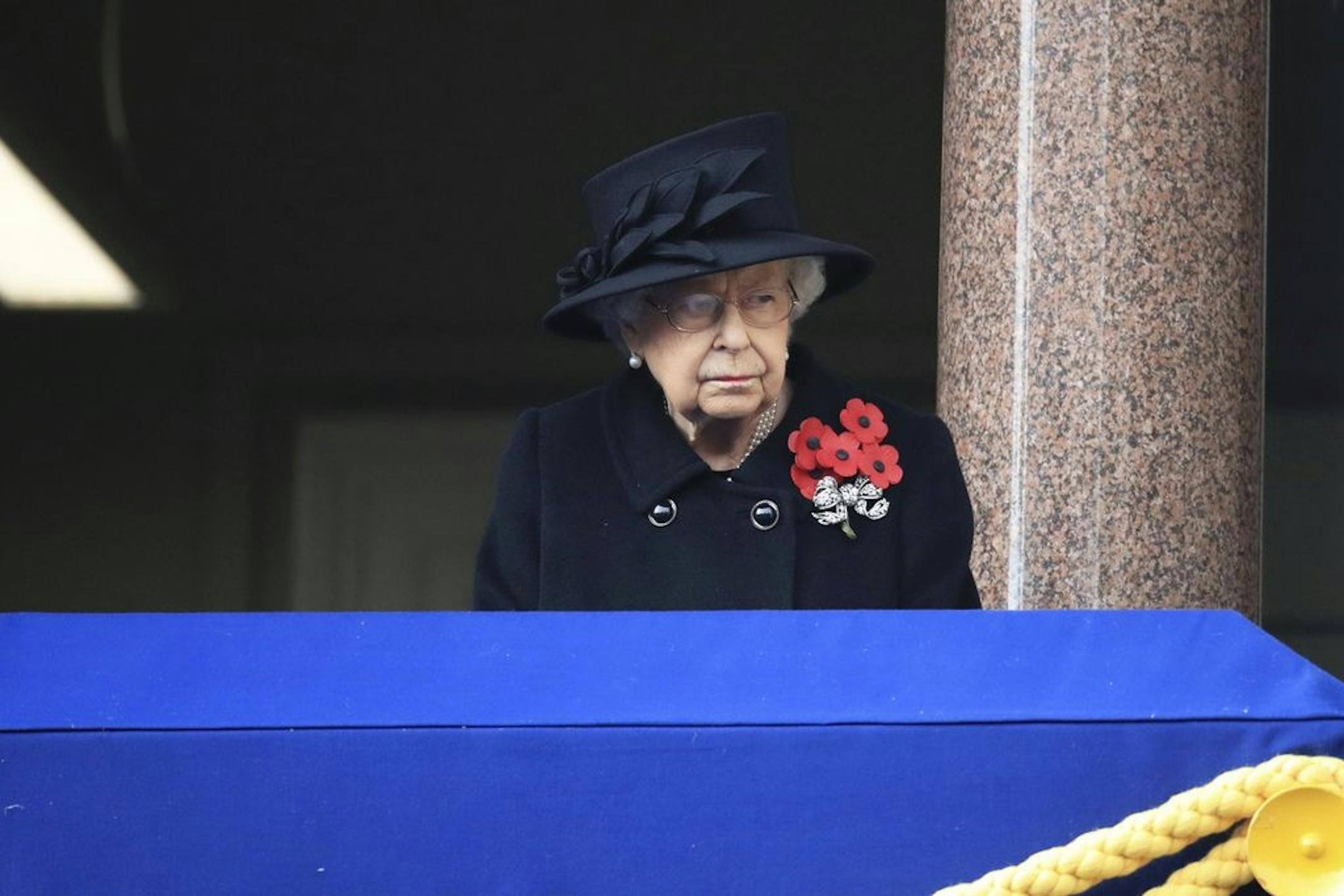 Britain's Queen Elizabeth II watches from the balcony of the Foreign Office, at the start of the Remembrance Sunday service at the Cenotaph, in Whitehall, London, Sunday Nov. 8, 2020.