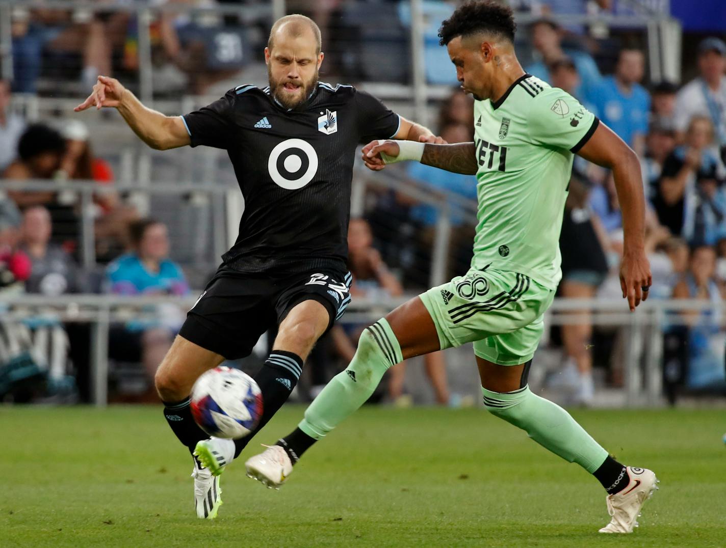 Austin FC defender Julio Cascante, right, kicks the ball away from Minnesota United forward Teemu Pukki, left, in the second half of an MLS soccer game Saturday, July 8, 2023, in St. Paul, Minn. (AP Photo/Bruce Kluckhohn)