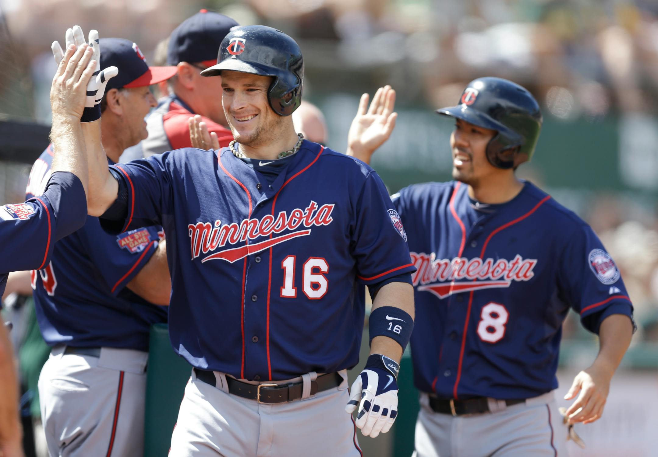 The Twins' Josh Willingham (16) received congratulations from teammates after hitting a two-run homer in the eight inning that also scored Kurt Suzuki (8) for a 4-1 lead against Oakland.