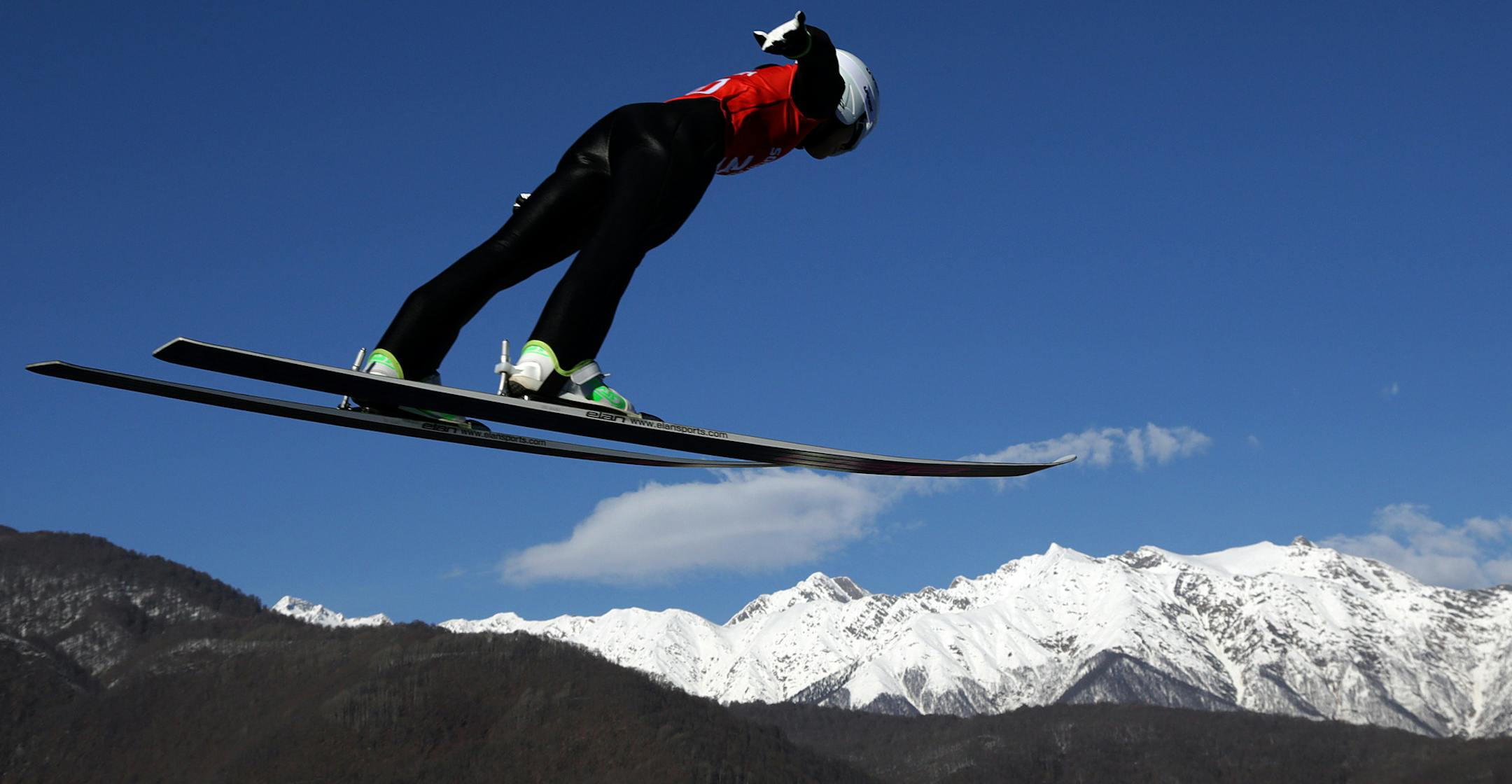 Japan's Sara Takanashi soars through the air during a women's ski jumping training session at the 2014 Winter Olympics, Saturday, Feb. 8, 2014, in Krasnaya Polyana, Russia. (AP Photo/Matthias Schrader)
