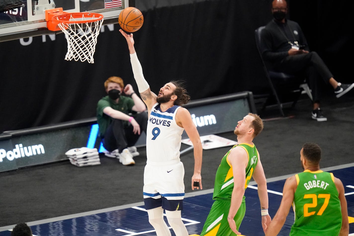 Timberwolves guard Ricky Rubio lays up the ball as Utah guard Joe Ingles, center, defends