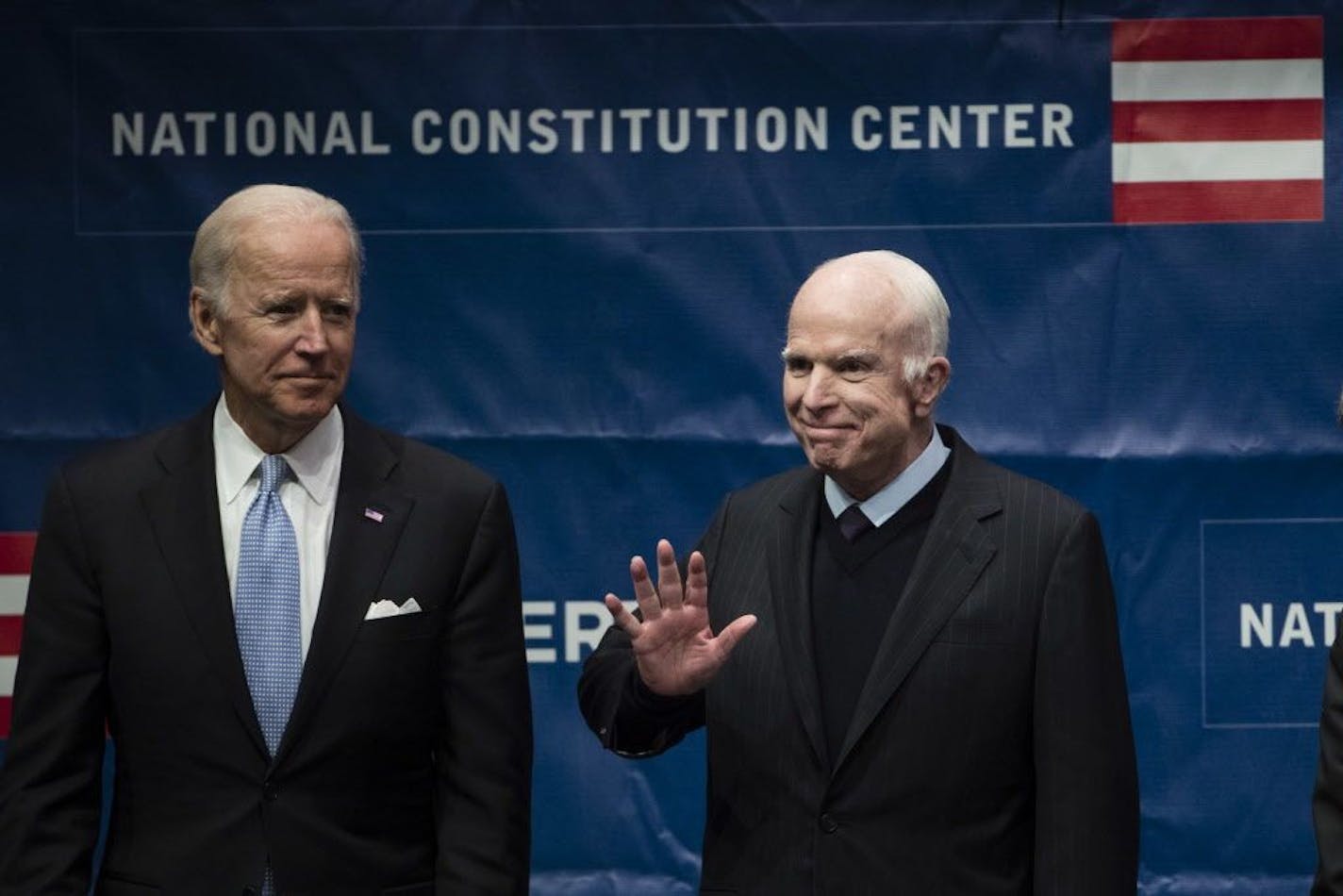 Sen. John McCain, R-Ariz., right, accompanied by former Vice President Joe Biden, waves as he takes the stage before receiving the Liberty Medal in Philadelphia, Monday, Oct. 16, 2017. The honor is given annually to an individual who displays courage and conviction while striving to secure liberty for people worldwide.