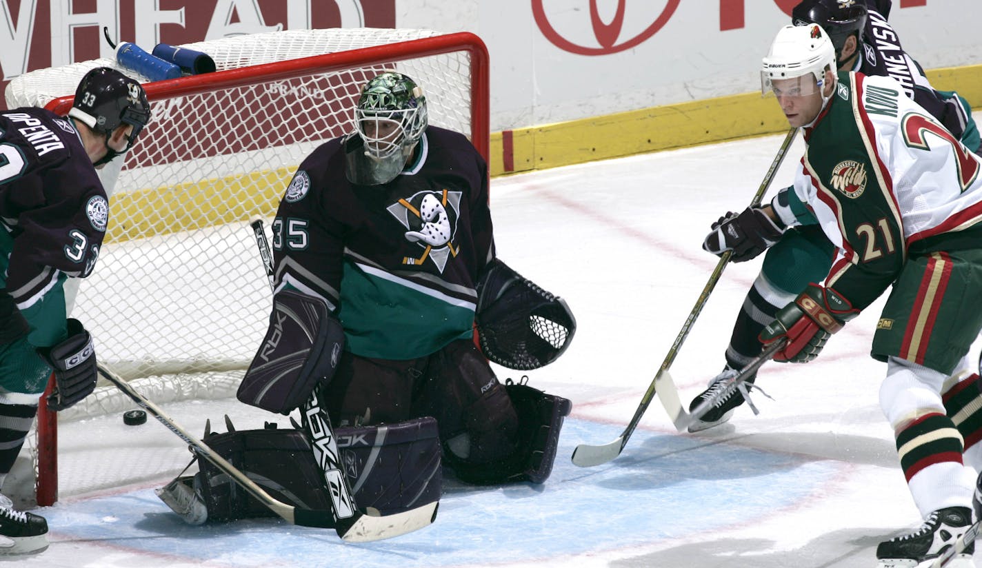 Minnesota Wild's Mikko Koivu (21) of Finland looks up after he shot the puck past Anaheim Mighty Ducks goalie Jean-Sebastien Giguere (35) for a goal during the first period as the Mighty Ducks' Joe DiPenta, left, and Vitaly Vishnevski, of Russia, look on Sunday, Nov. 6, 2005, in Anaheim, Calif. (AP Photo/Henry J. DiRocco) ORG XMIT: ANA102