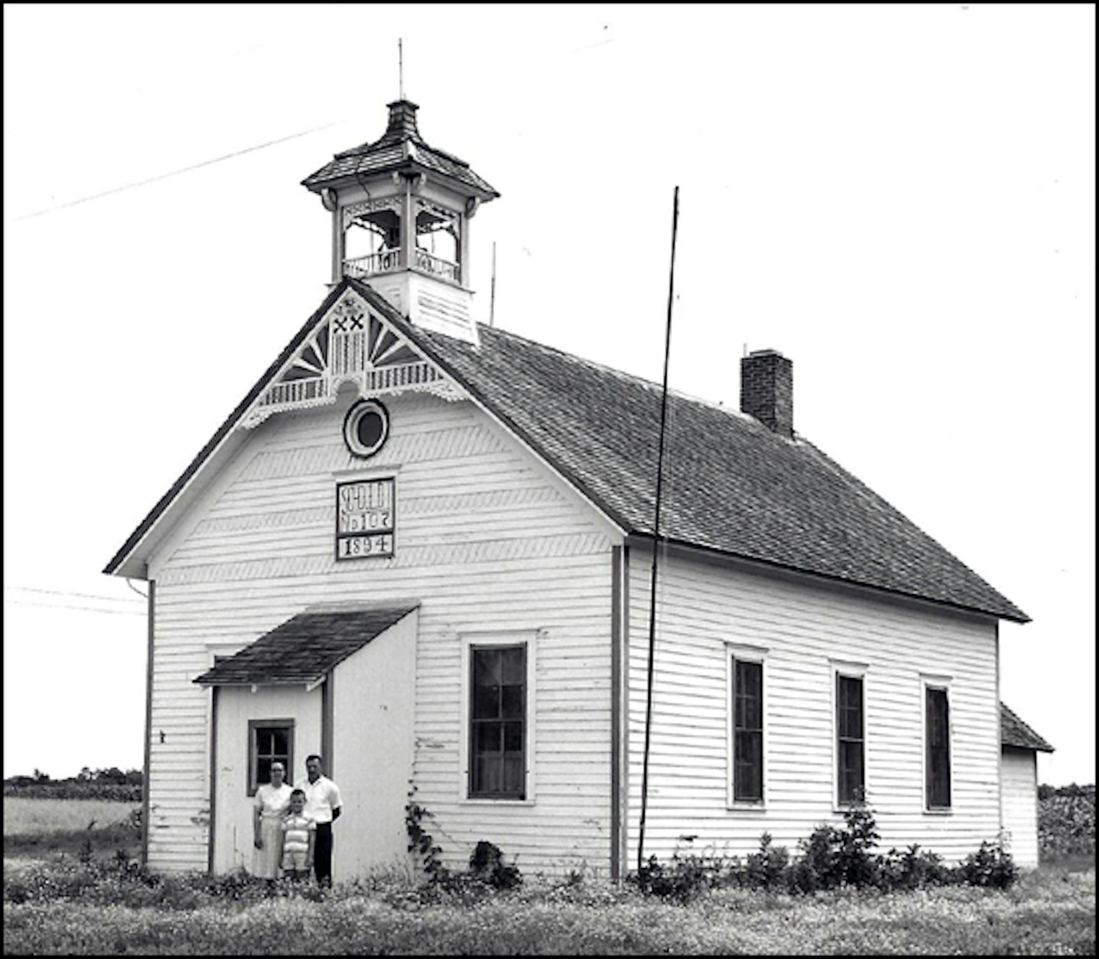 This picture was taken in the summer 1965 of the Burschville one room school house (it closed in 1967). Standing in front is Agnes Weinand (my great aunt), Willard Weinand (my father) and me – and at the time I would have been a third-grader at the school. Agnes, Willard and I all attended the school. As did my grandfather, brothers and other relatives over the years.