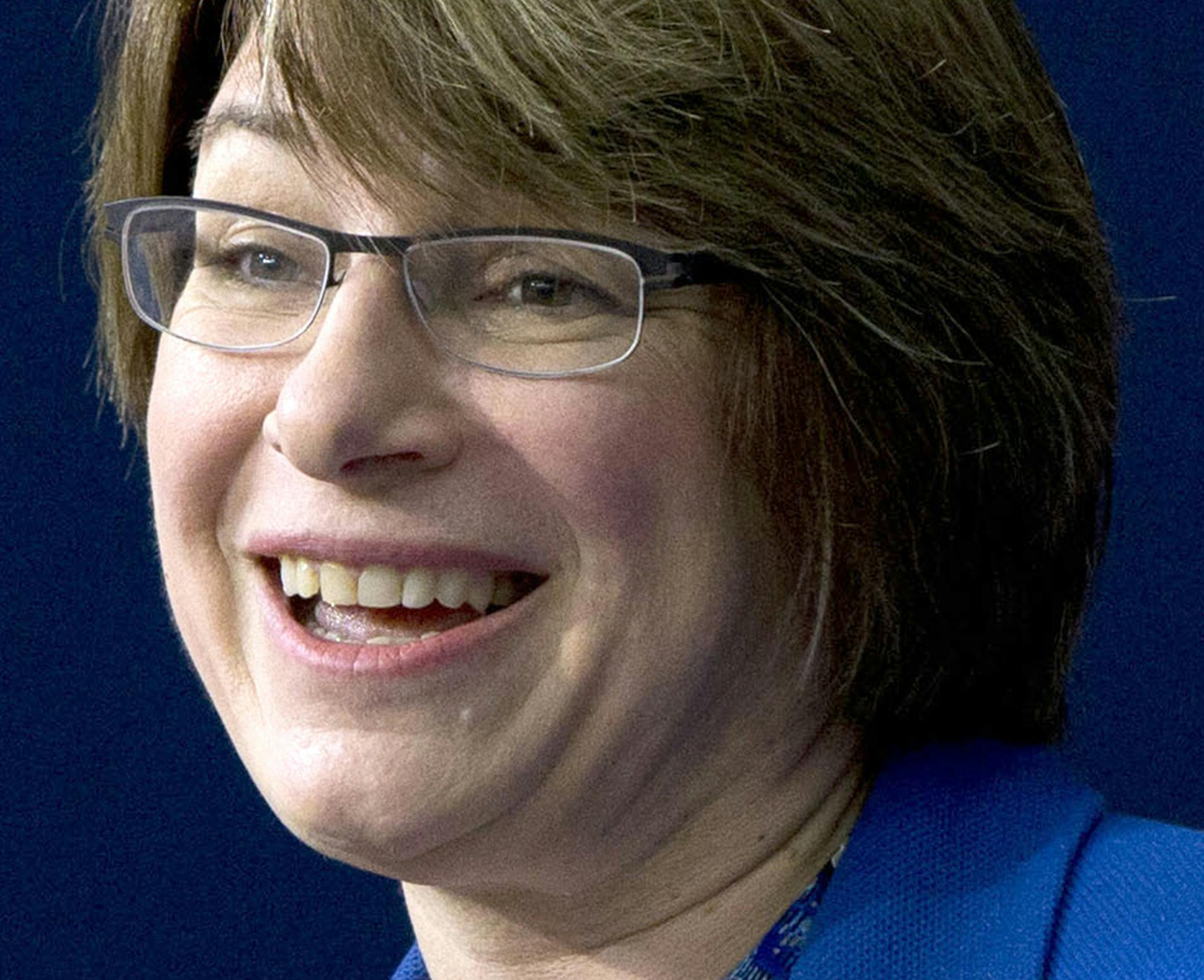 FILE - In this Feb. 18, 2015 file photo, Sen. Amy Klobuchar, D-Minn. speaks during the White House Summit on Countering Violent Extremism in Washington. Henry and Holt Company announced Thursday that Klobuchar is working on an Ïinspiring, wittyÓ book about her life and how to set aside Ïpartisan flame throwingÓ in politics. The book is called ÏThe Senator Next DoorÓ and is scheduled for Aug. 25. (AP Photo/Carolyn Kaster, File) ORG XMIT: MIN2015040217431559