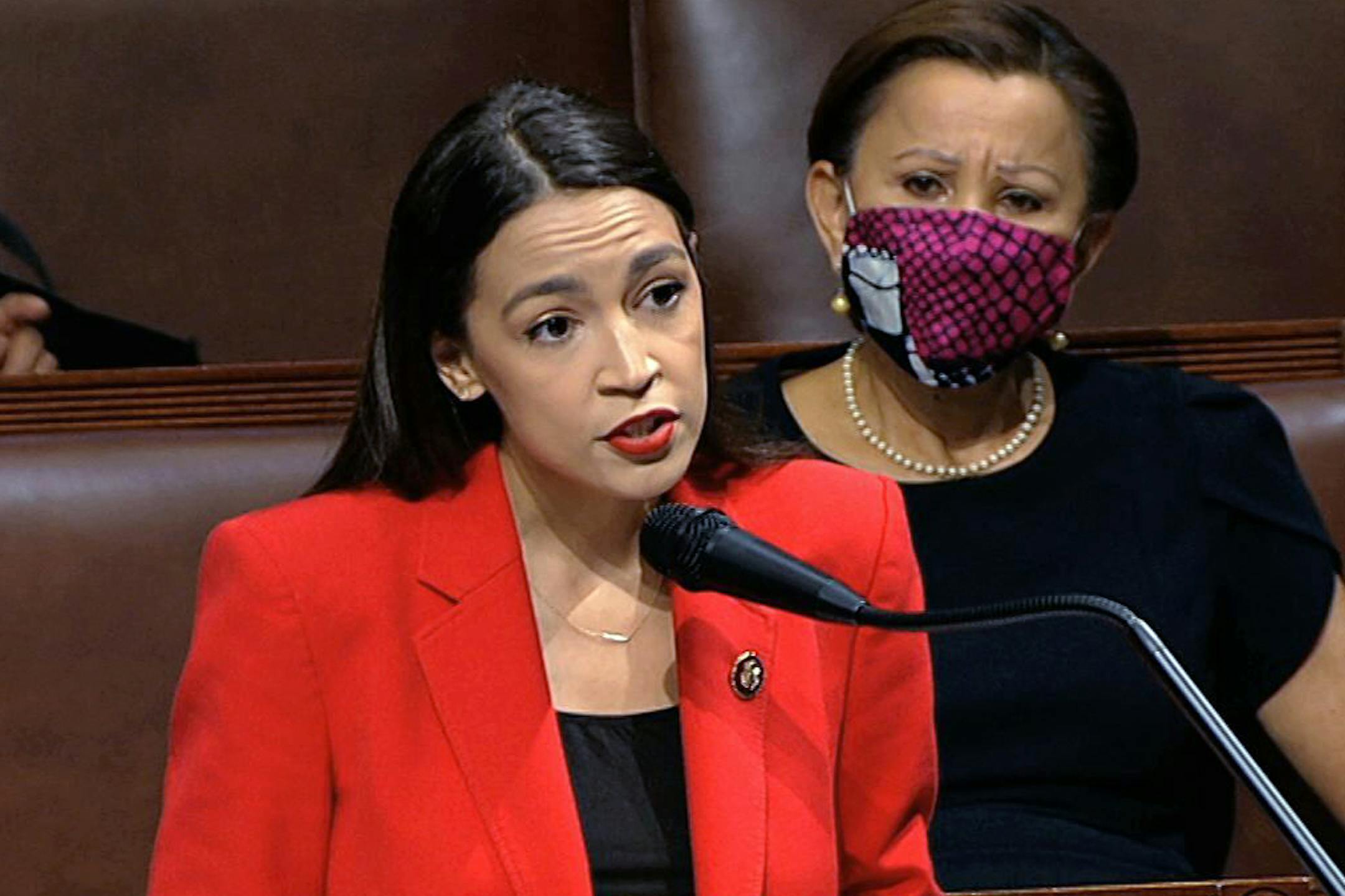 In this image from video, Rep. Alexandria Ocasio-Cortez, D-N.Y., speaks on the House floor, Thursday, July 23, 2020 on Capitol Hill in Washington. Ocasio-Cortez's objections to a Republican lawmaker's verbal assault on her expanded Thursday as she and other Democrats took to the House floor to demand an end to a sexist culture of "accepting violence and violent language against women." Rep. Nydia Velázquez, D-N.Y., is seated right. (House Television via AP)
