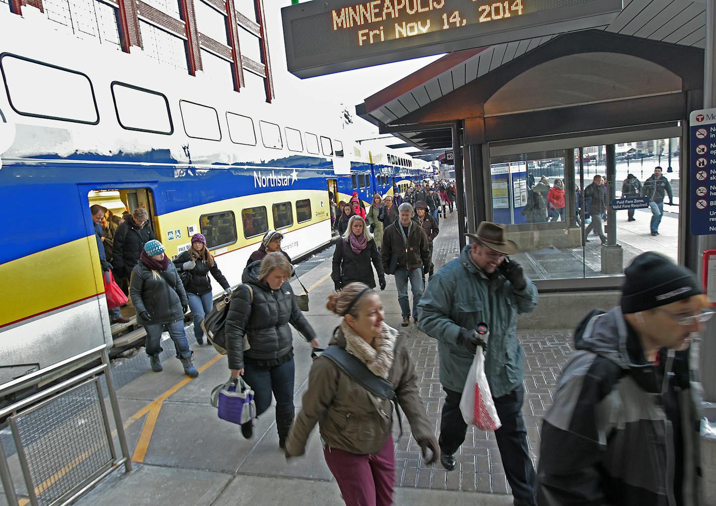 Northstar Passengers made their way off the train early Friday, November 14, 2014 at the Target Field Station in Minneapolis, MN. Five years in, the state's first commuter rail line has seen ridership and its on-time ratings slip due to chronic delays as Northstar competes for track time with oil trains and other freight traffic. Northstar, which links the Hwy 10 corridor to downtown Minneapolis, cost $320 million to build. Last year it averaged 2,783 weekday boardings each week. ] (ELIZABETH FL