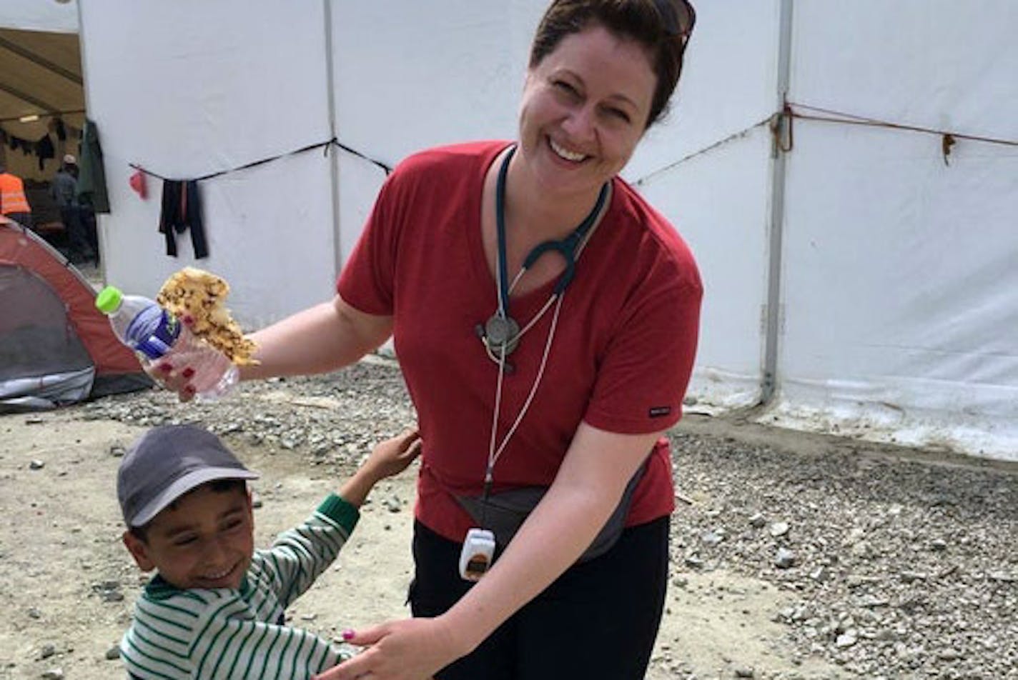 Lindsey Smith and a boy at a refugee camp on the border of Greece and Macedonia in 2016.