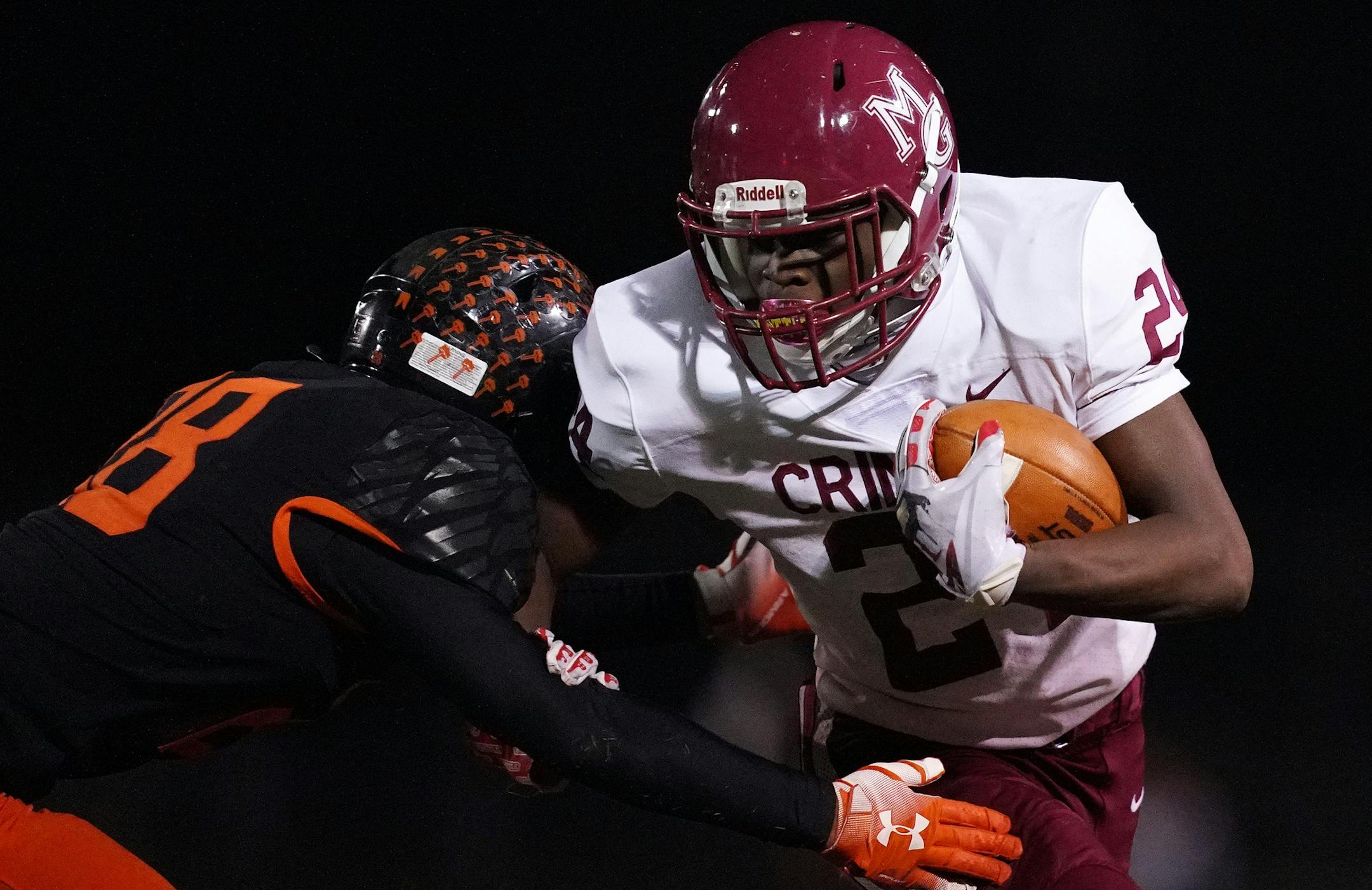 Maple Grove running back Derrick Jameson (24) was tackled by defensive linesman Rick Jallah (18) as he ran the ball in the first half. ] ANTHONY SOUFFLE • anthony.souffle@startribune.com Maple Grove played Osseo in a MSHSL football game Friday, Oct. 30, 2020 at Osseo High School in Osseo, Minn.