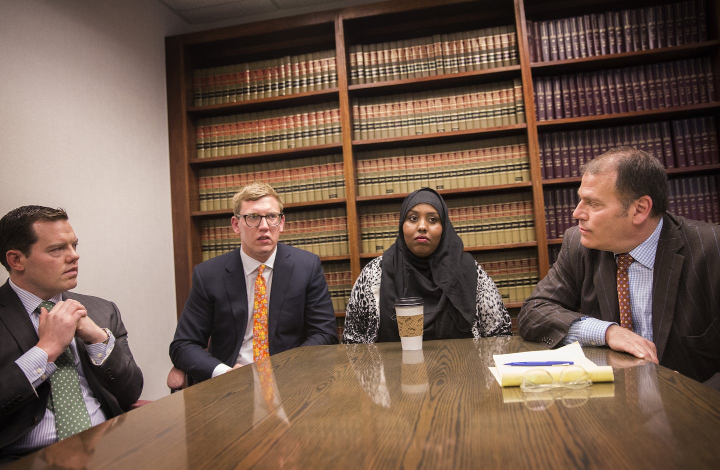 Hamdi Ali Osman, center, sits with lawyers Jeffrey Storms, from left, Andrew Irlbeck and Paul Applebaum during a press conference at Applebaum Law Firm in St. Paul. ] (Leila Navidi/Star Tribune) leila.navidi@startribune.com BACKGROUND INFORMATION: Thursday, April 7, 2016 at Applebaum Law Firm in St. Paul. Hamdi Ali Osman, 26, was named and charged in the now known as fabricated story of sex trafficking by St. Paul Police Sgt. Heather Weyker in 2010. Osman has spent six years on and off in federa