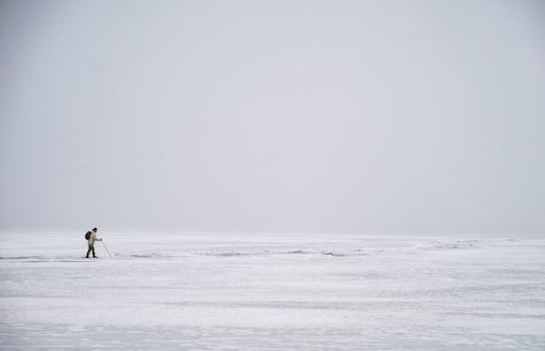 Jon Michels, an ice cave tour guide, checked the ice thickness while walking on Lake Superior in February 2020.