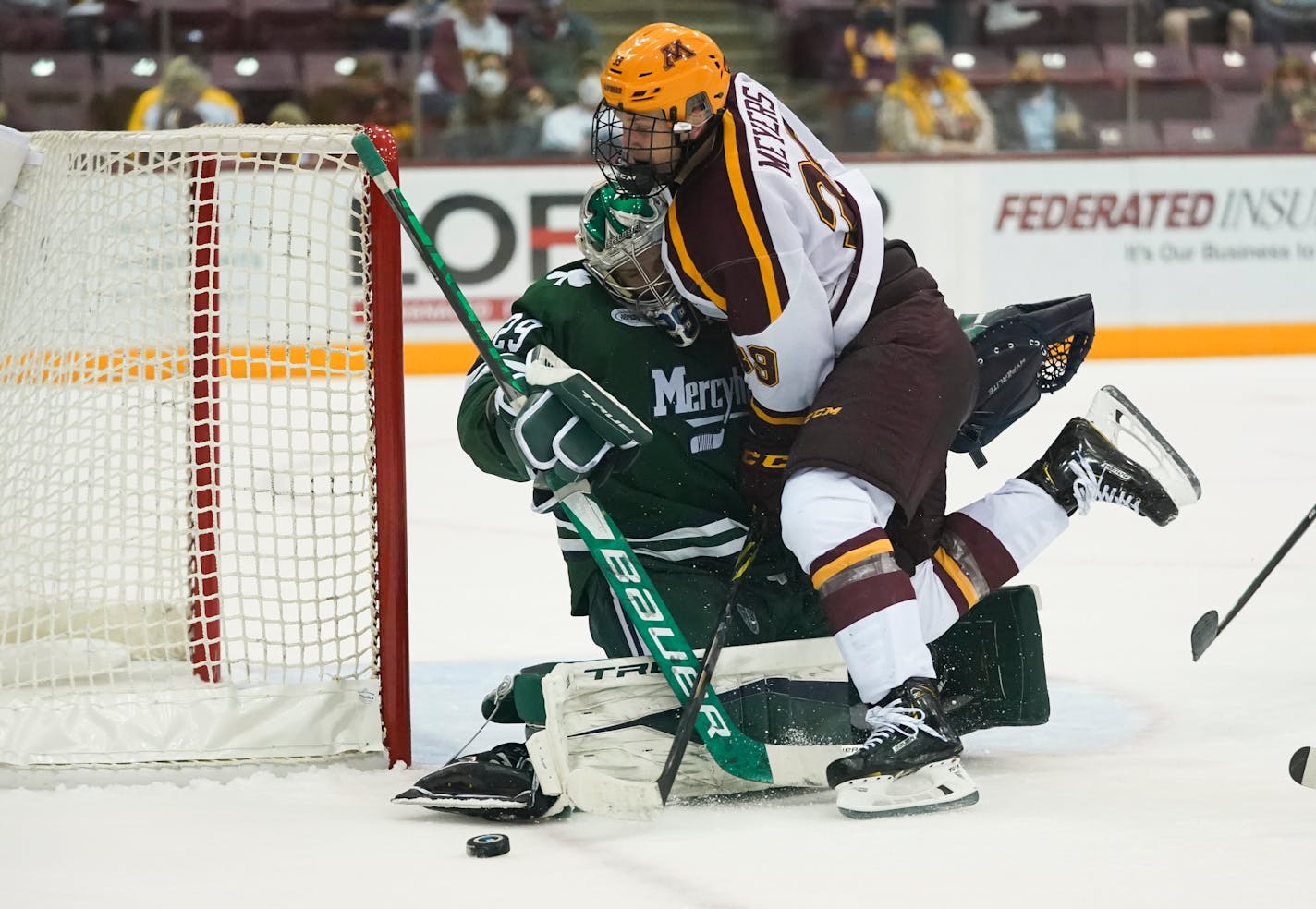 Gophers forward Ben Meyers crashed into Mercyhurst goaltender Hank Johnson during Friday night's game.