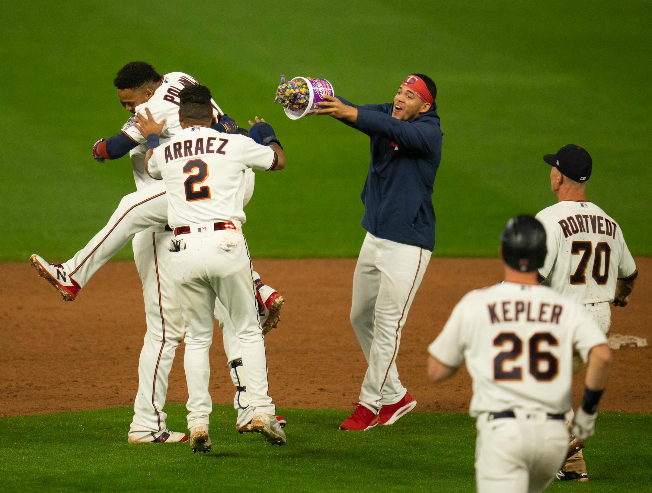 Twins pitcher Jose Berrios tossed bubble gum as Twins first baseman Miguel Sano (22) hoisted designated hitter Jorge Polanco (11) up after Polanco hit the ninth inning walk off single to give the Twins the win. Twins second baseman Luis Arraez (2) also joined the celebration.