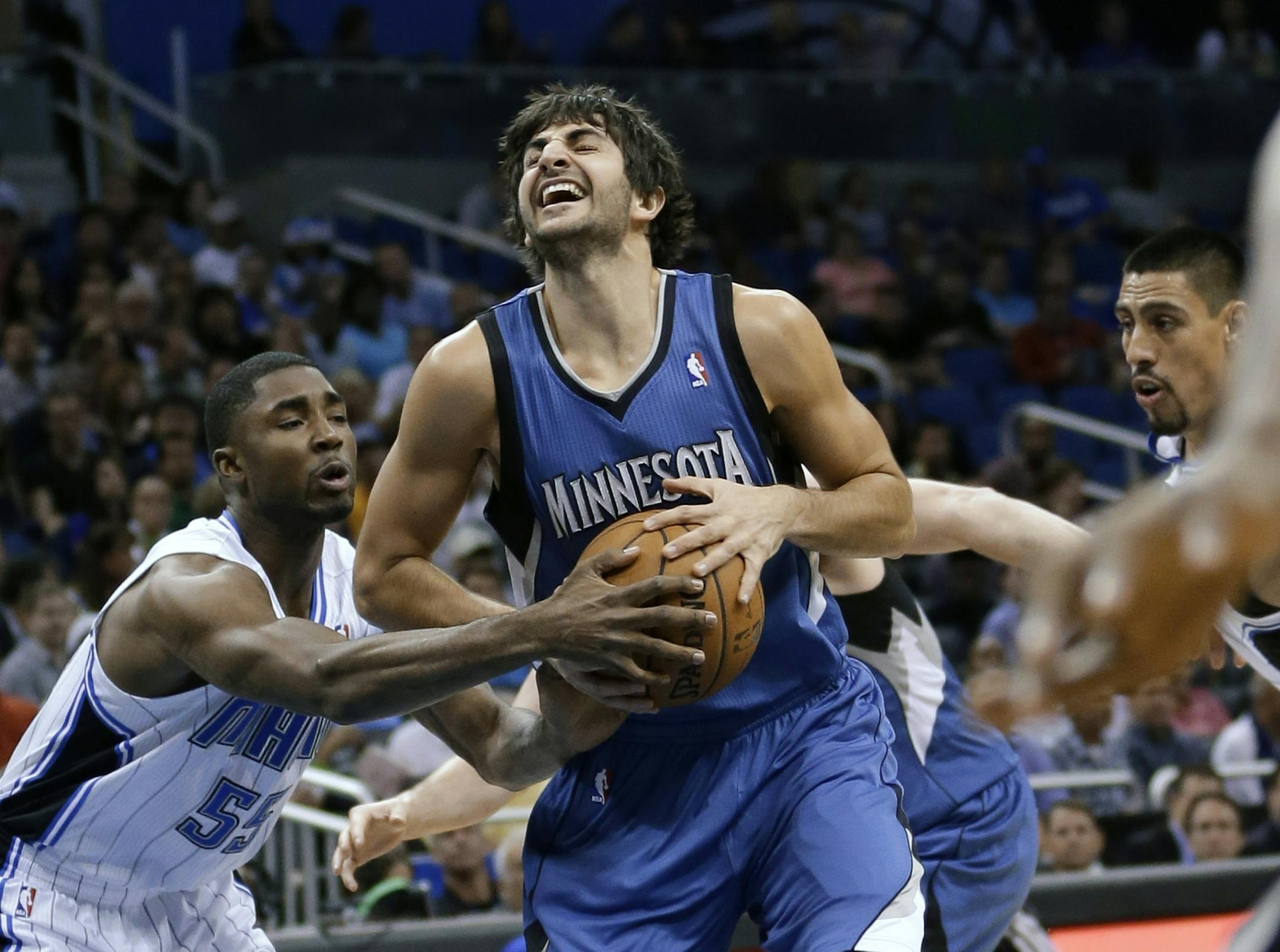 Minnesota Timberwolves' Ricky Rubio, center, of Spain, makes a move to get between Orlando Magic's E'Twaun Moore, left, and Gustavo Ayon during the first half of an NBA basketball game, Monday, Dec. 17, 2012, in Orlando, Fla.