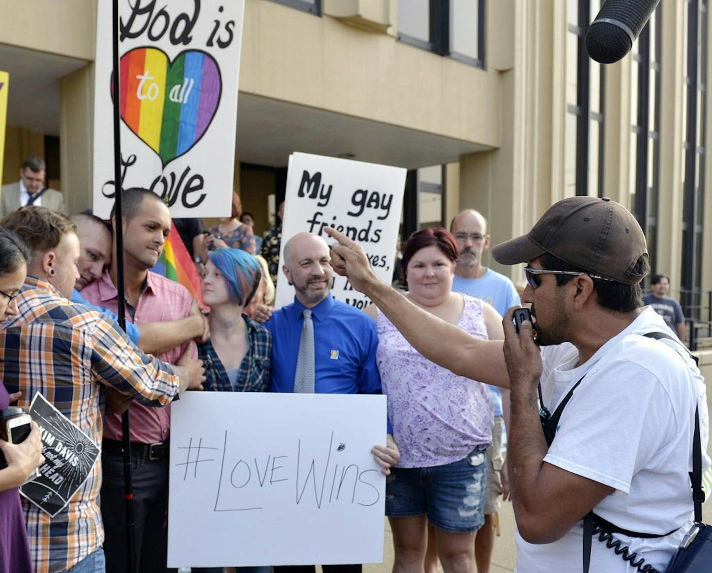 Edgar Orea, right, preaches to a group of same sex marriage supporters that have gathered in Ashland, Ky.