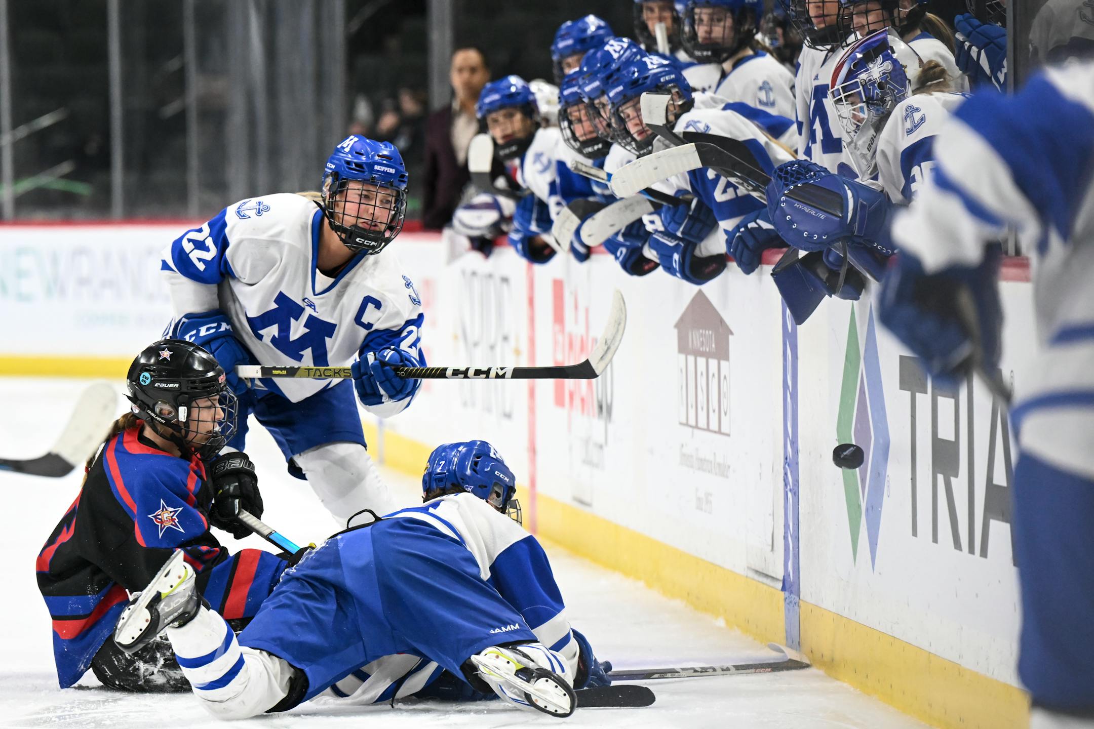 Minnetonka defenseman Elly Klepinger (22) hits the puck in to the corner during the second period.