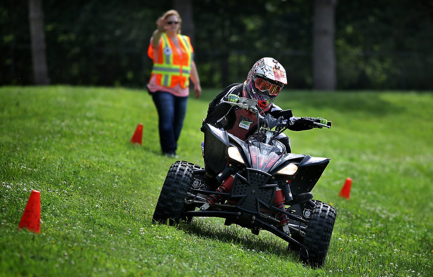 Owen Farmer, 11, Faribault, shifted his body weight to compensate for the steep angle of a hill while driving through an obstacle course a DNR ATV staining class at the Dakota County Fairgrounds in June. Owen and his family are avid ATV riders. ] JIM GEHRZ &#x201a;&#xc4;&#xa2; jgehrz@startribune.com / Farmington, MN 6/28, 2014 / 9:00 AM / BACKGROUND INFORMATION: The Minnesota DNR conducted a training class for ATV riders, particularly aimed at younger riders at the Dakota County Fairgrounds in F