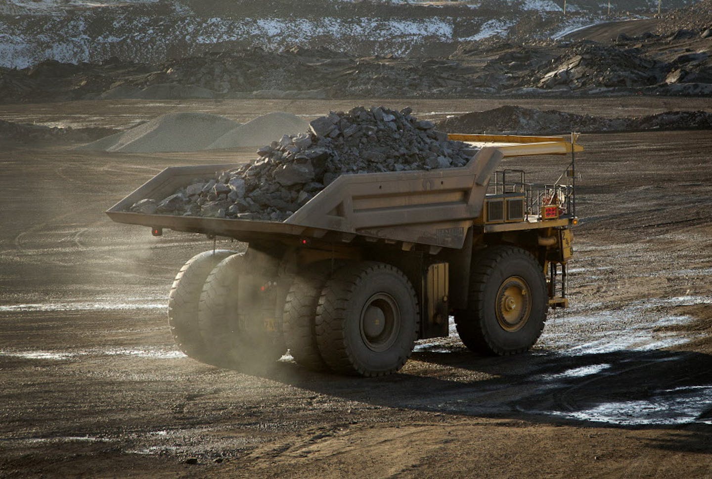 A 240-ton capacity production truck drives out of an open pit mine with a load of taconite heading to the Hibbing Taconite Co. pellet manufacturing plant.