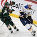 St. Louis Blues' Sammy Blais (64) controls the puck against Minnesota Wild's Nate Prosser (39) during the third period of an NHL hockey game Saturday,