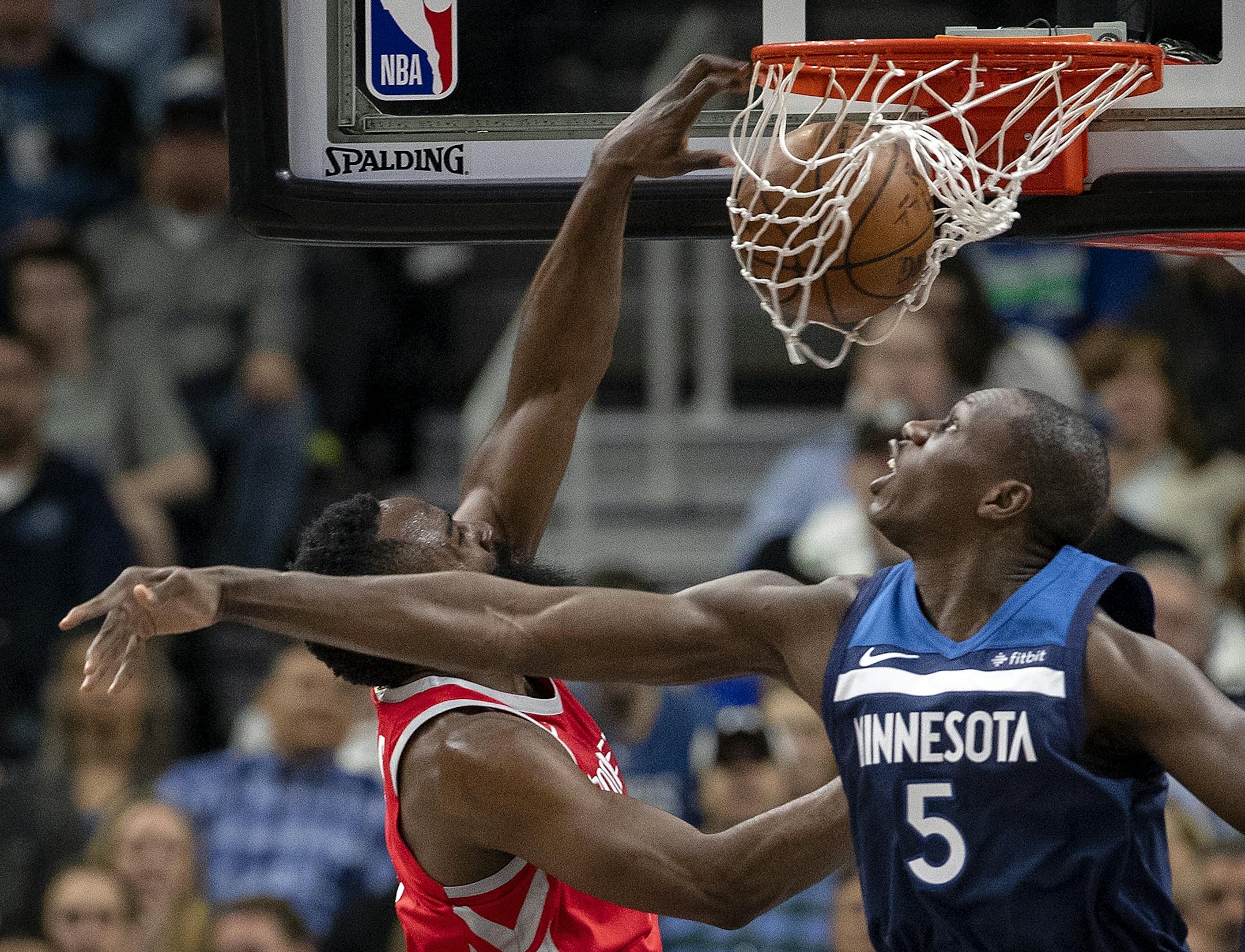 James Harden (13) dunked the ball while being defended by Gorgui Dieng (5) in the first quarter.