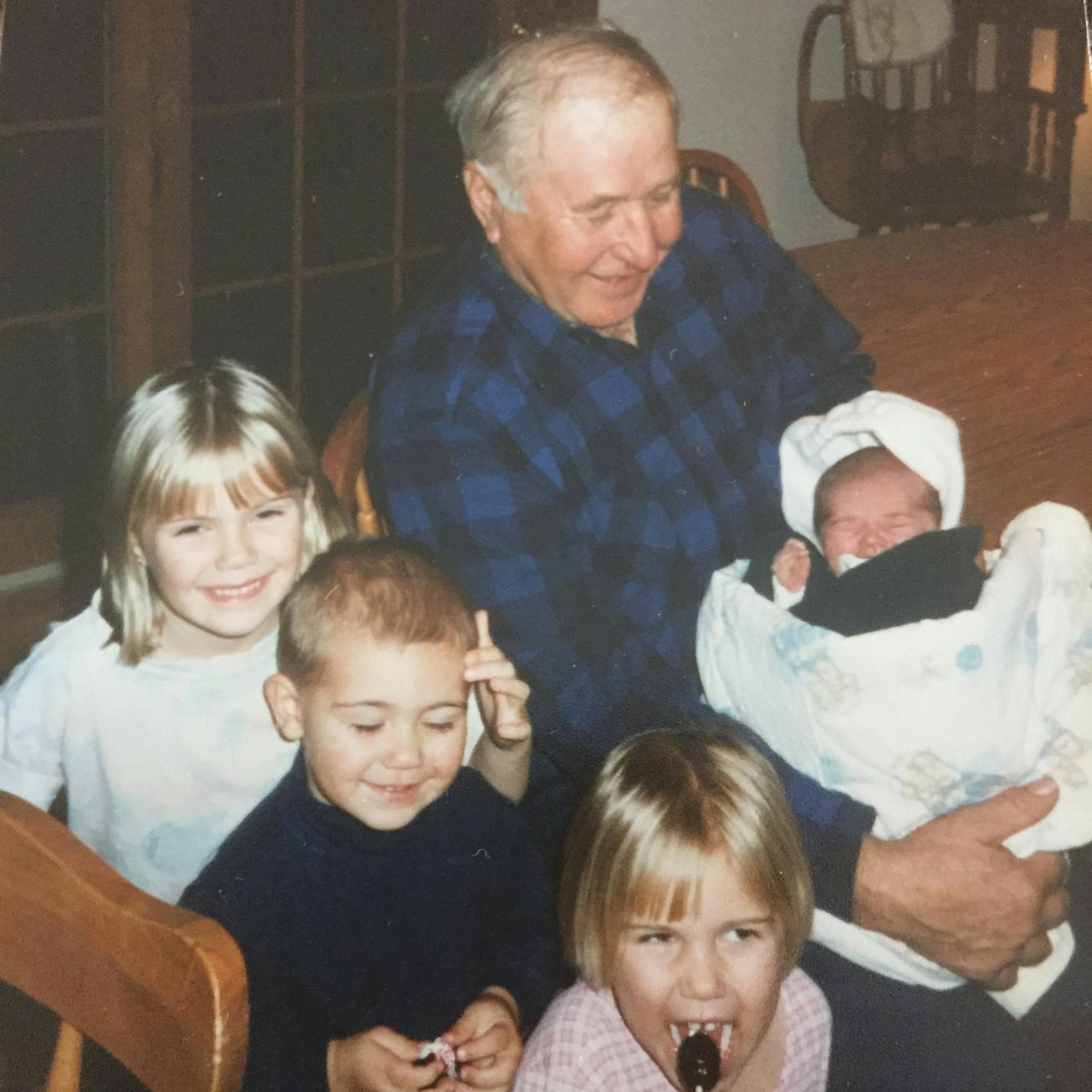 Photo courtesy of Boecker family: Earl Olander, 90, who was killed over the weekend in his rural Carver County home, was a close friend of the Boecker family. In this 1995 photo, he appears with the four Boecker children: Baby is Tatiana, Larissa has sucker, the boy is Billy, and the girl on Earl's left is Ashley. Credit: Provided by Maria Boecker