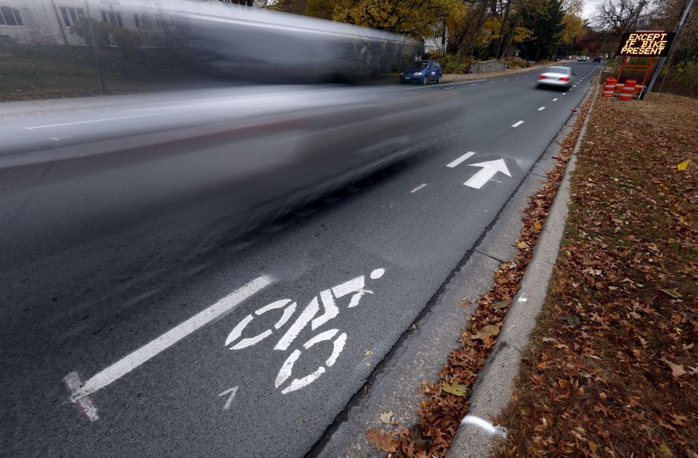 Cars drove down Wooddale Ave. near 50th St. in Edina near a new bike lane on Thursday.