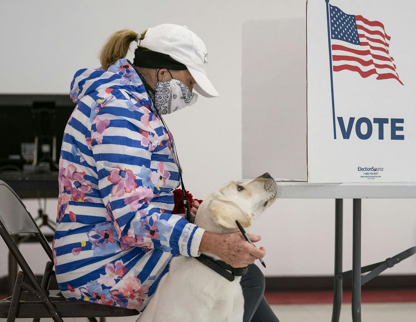 Catherine Anderson brought her dog, Ivy, to vote in the Wisconsin Primary at the Billings Park Civic Center on Tuesday. ]
ALEX KORMANN &#x2022; alex.kormann@startribune.com Wisconsin primaries took place on Tuesday April 7, 2020 in the middle of the COVID-19 pandemic. Wisconsin governor Tony Evers issued an executive order on Monday to postpone the primaries until June but the state supreme court overruled the order.