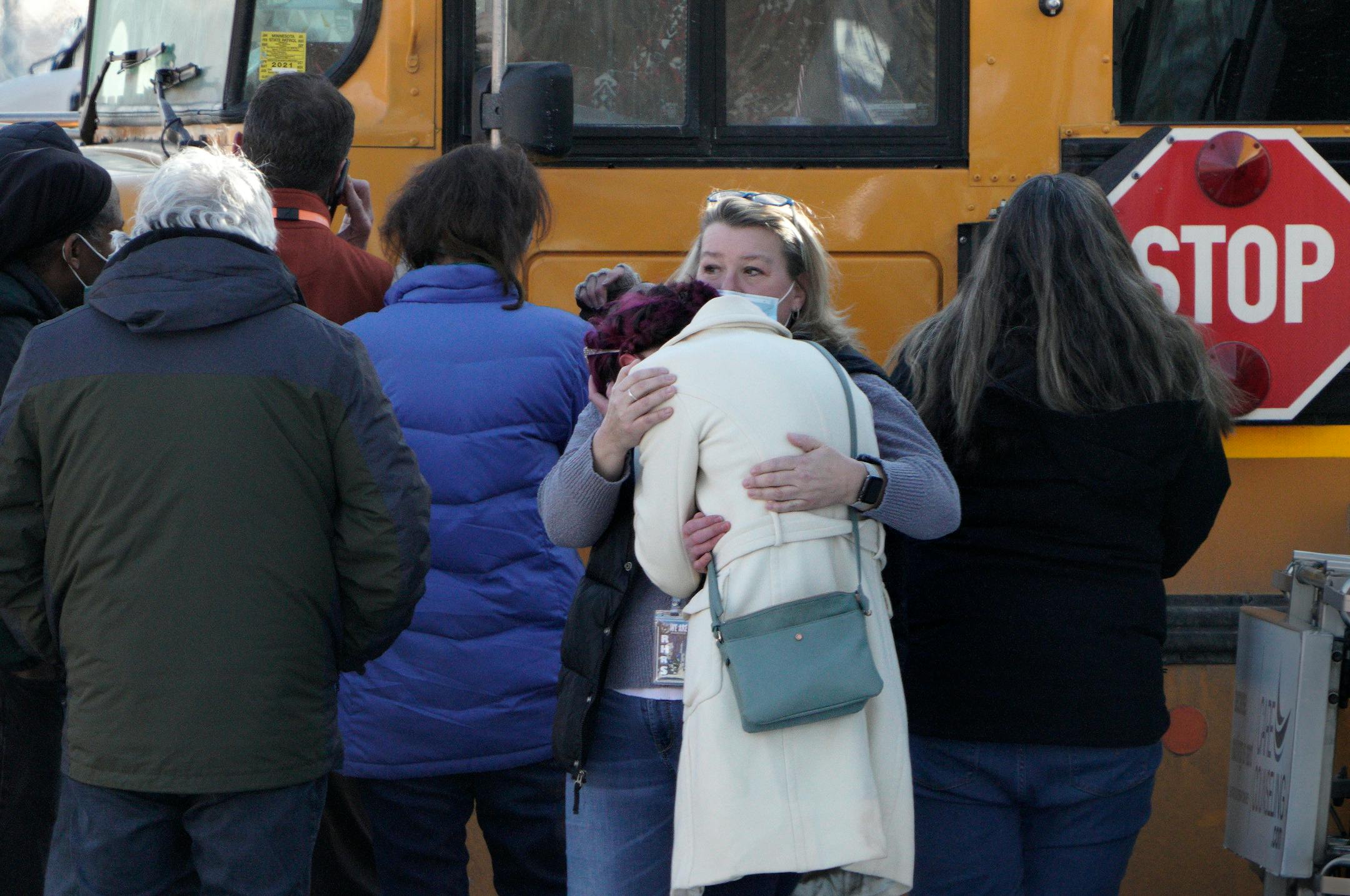 One student was shot and killed, and another severely wounded on the sidewalk outside the South Education Center, an alternative school in the Intermediate District 287 that serves students from pre-K to age 21. In this photo, parents console each other while waiting to be reunited with their children after the school was locked down for a few hours Tuesday, Feb. 1, 2022 in Richfield, Minn. ] Brian Peterson • brian.peterson@startribune.com