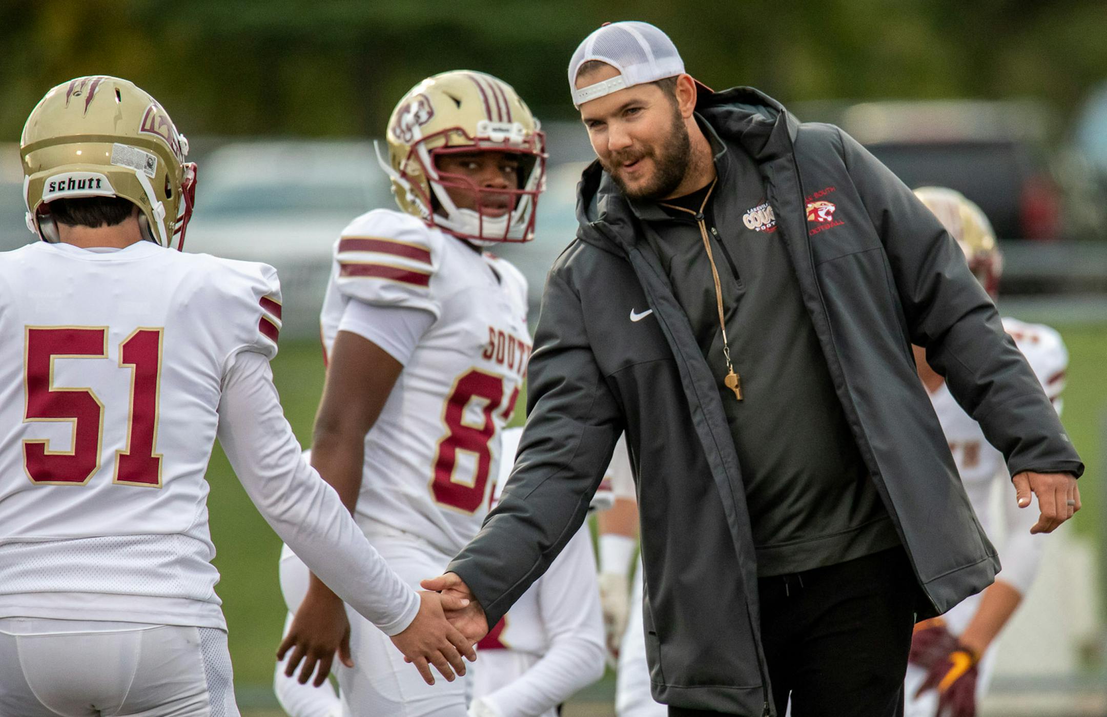 Lakeville South Head Coach Ben Burk encourages Lakeville South LB Logan Rasmussen (51) before game against Lakeville North. [ Special to Star Tribune, photo by Matt Blewett, Matte B Photography, matt@mattebphoto.com, October 3, 2019, Lakeville North High School, Lakeville, Minnesota, SAXO 1009672801 PREP.lake