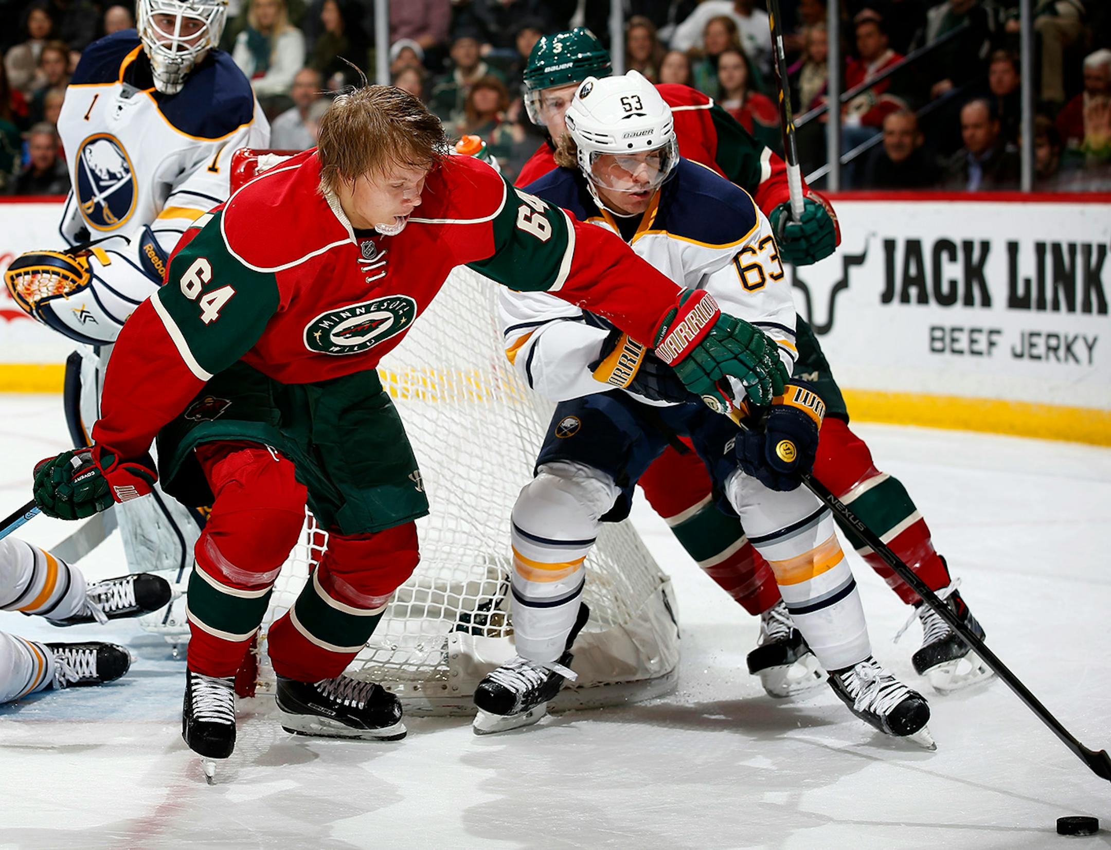 Mikael Granlund (64) fought for the puck with Tyler Ennis (63) in the first period. ] CARLOS GONZALEZ cgonzalez@startribune.com - November 13, 2014, St. Paul, Minn., Xcel Energy Center, NHL, Minnesota Wild vs. Buffalo Sabres
