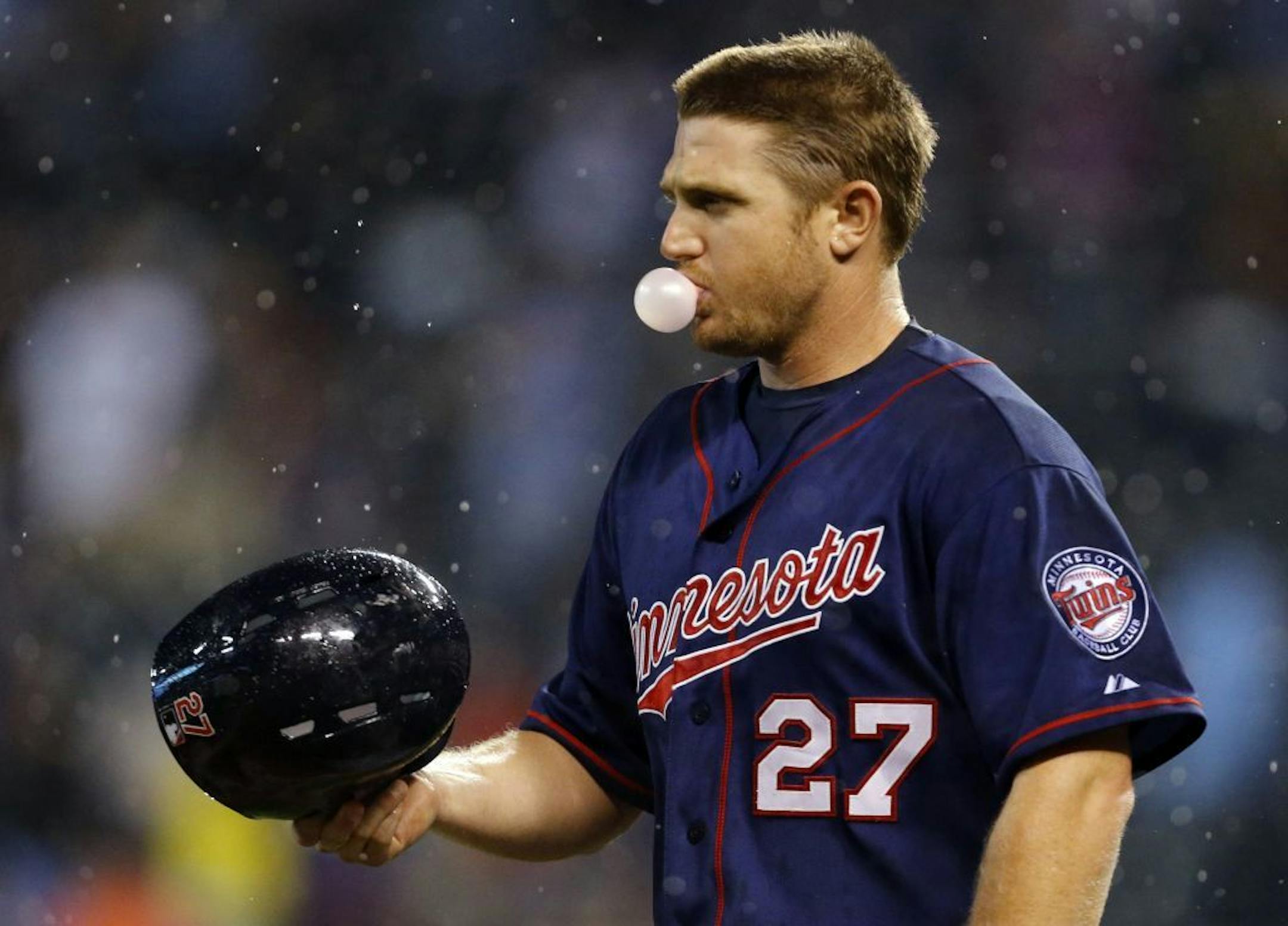 Minnesota Twins' Chris Parmelee blows a bubble between pitches during the ninth inning Tuesday night.