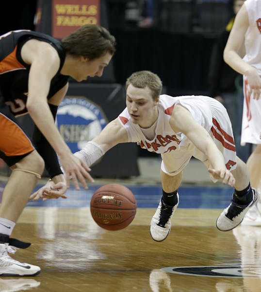 Austin's Zach Wessels and Marshall's Tanner Bukowski battled for the ball during overtime of the boys' basketball Class 3A semifinals at the Target Ce