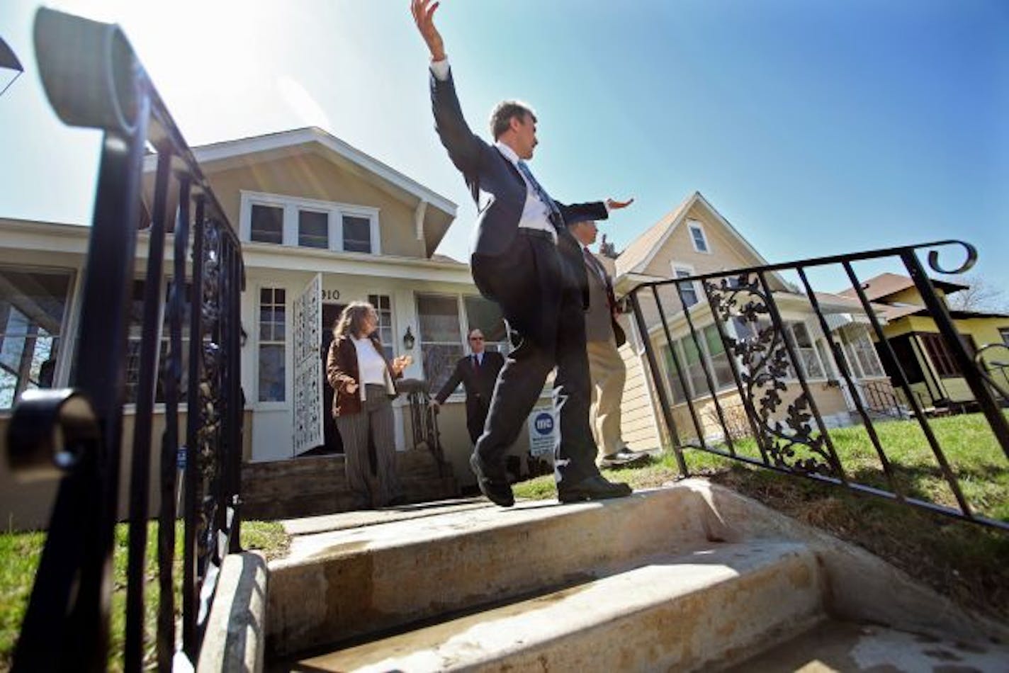 Minneapolis Mayor R.T. Rybak greeted St. Paul City Council Member Melvin Carter after a news conference Tuesday announcing $10 million in loans by the Mc­Knight Foundation to help stabilize metro and rural communities in the midst the foreclosure crisis. The announcement was made at a foreclosed house in St. Paul.