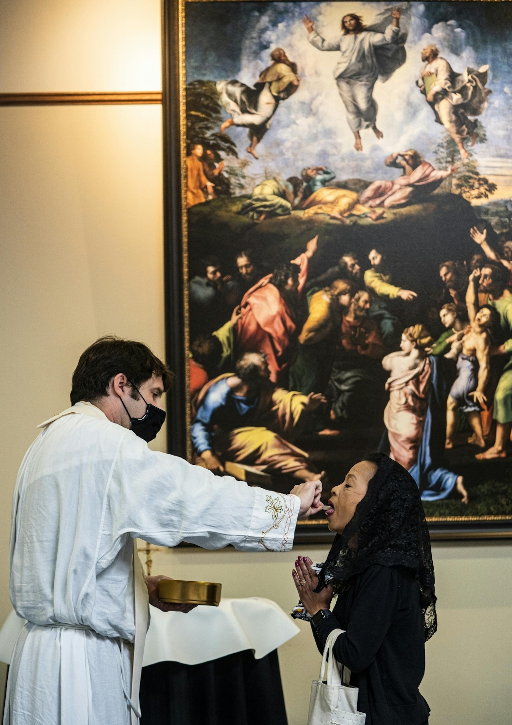 Father John Paul Erickson gave communion to parishioner Del Sliter who said, "it's amazing. This is a glorious day."