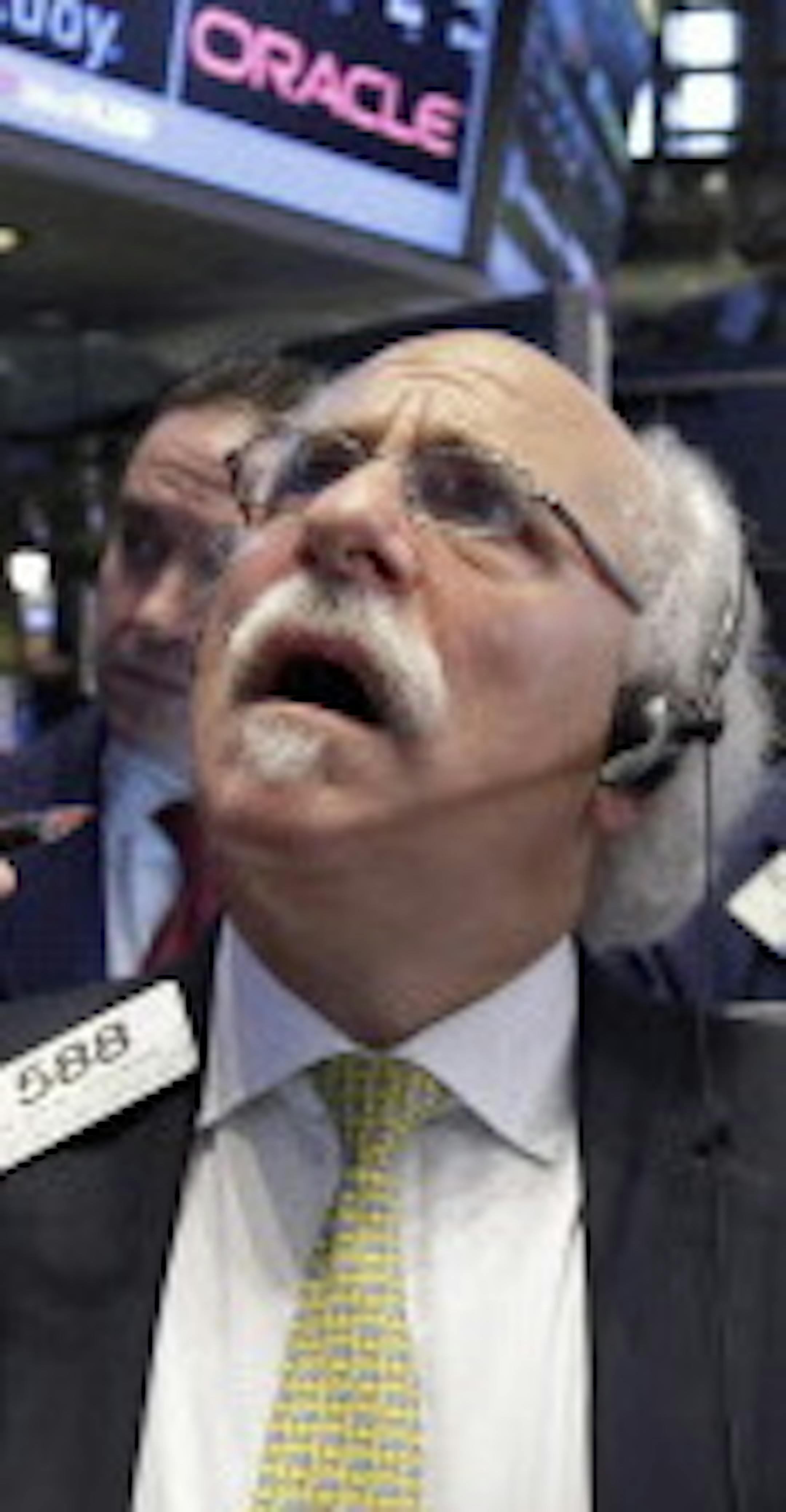 Peter Tuchman, foreground right, works with fellow traders on the floor of the New York Stock Exchange, Monday, Aug. 24, 2015. U.S. stock markets plunged in early trading Monday following a big drop in Chinese stocks. (AP Photo/Richard Drew)