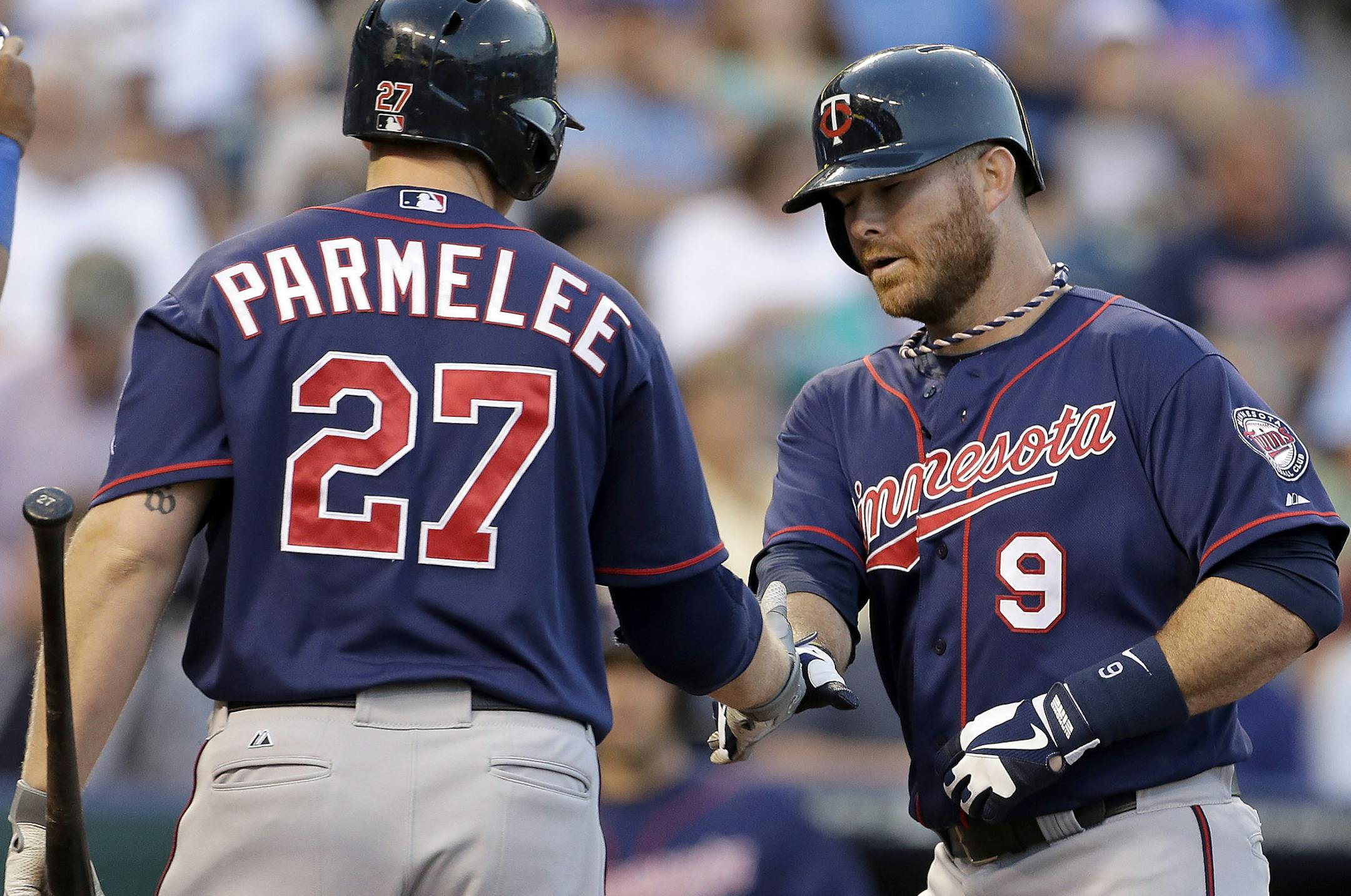 Minnesota Twins' Ryan Doumit (9) celebrates with Chris Parmelee (27) after hitting a solo home run during the fourth inning of a baseball game against the Kansas City Royals Tuesday, June 4, 2013, in Kansas City, Mo. (AP Photo/Charlie Riedel)